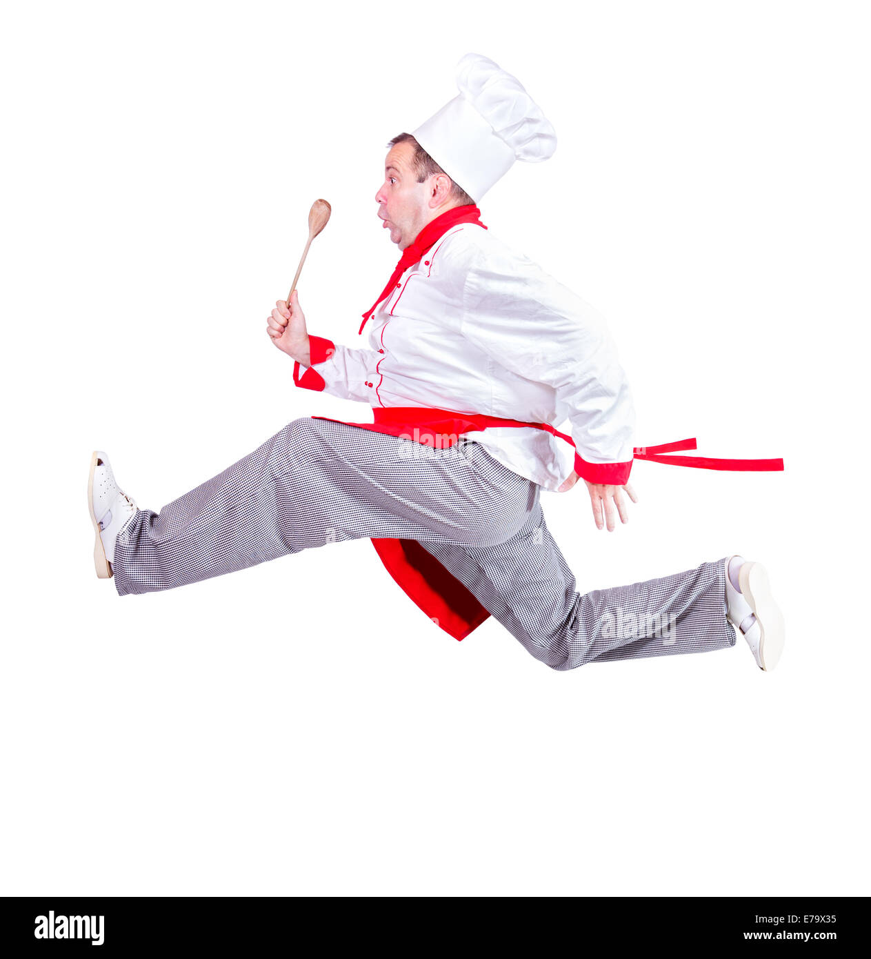 fat chef running with a wooden spoon on a white background Stock Photo