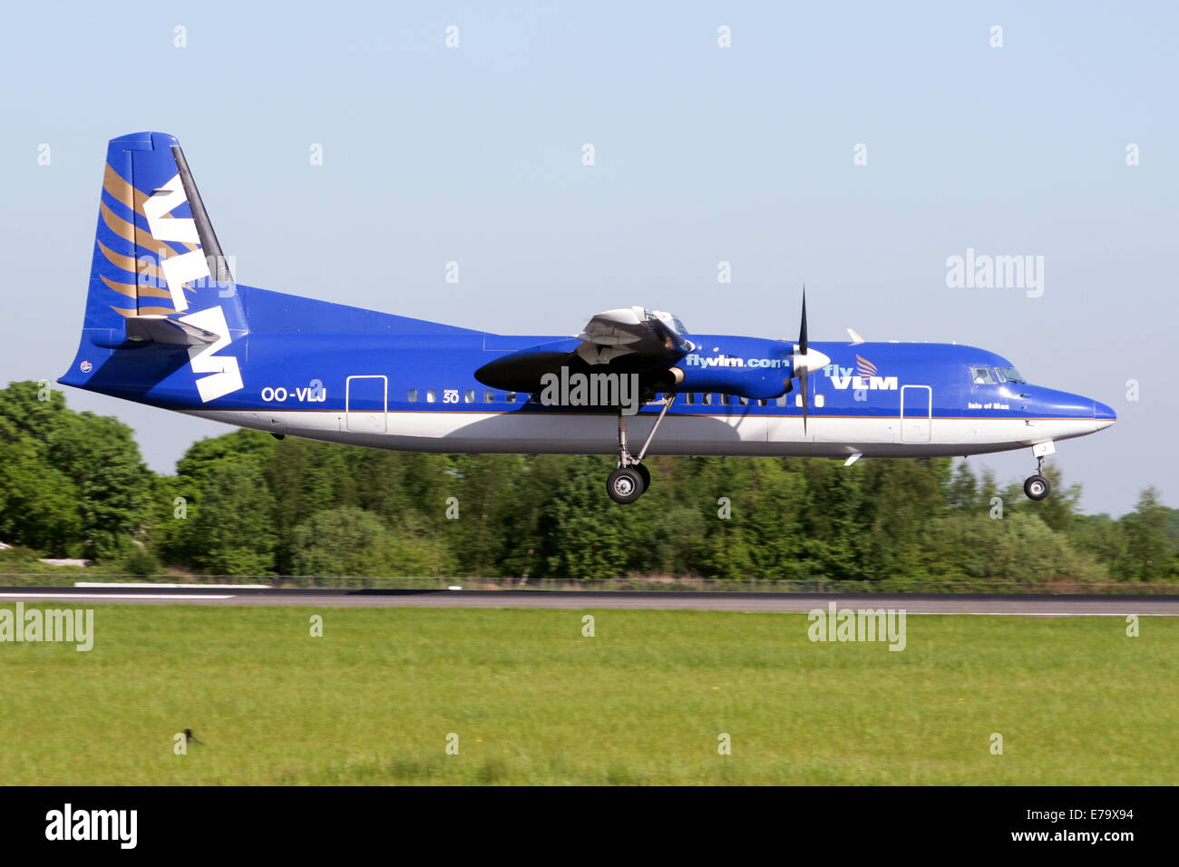 VLM Fokker 50 approaches runway 05R at Manchester airport. Stock Photo