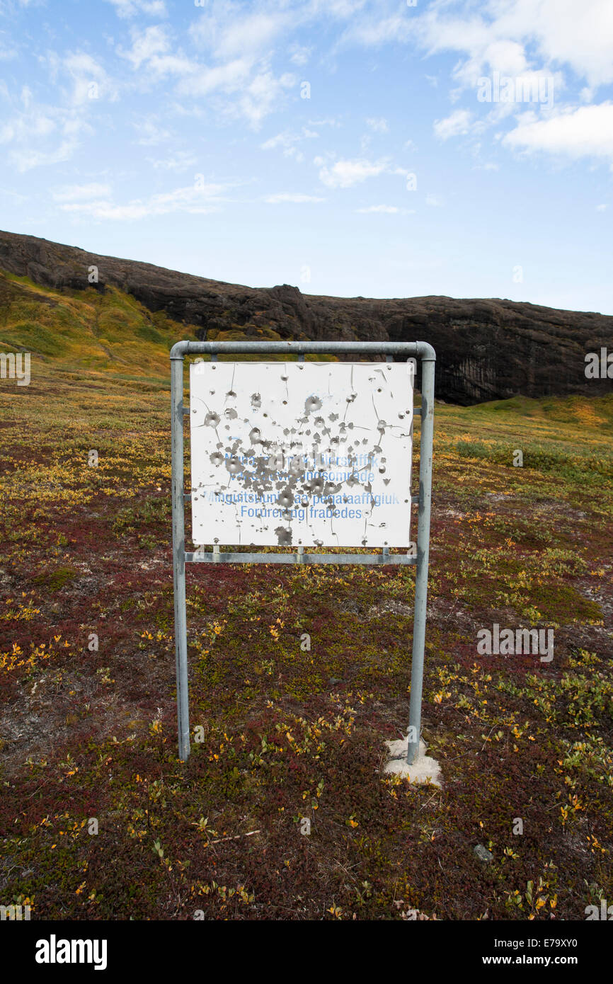 Bullet holes in a metal sign in Greenland Stock Photo