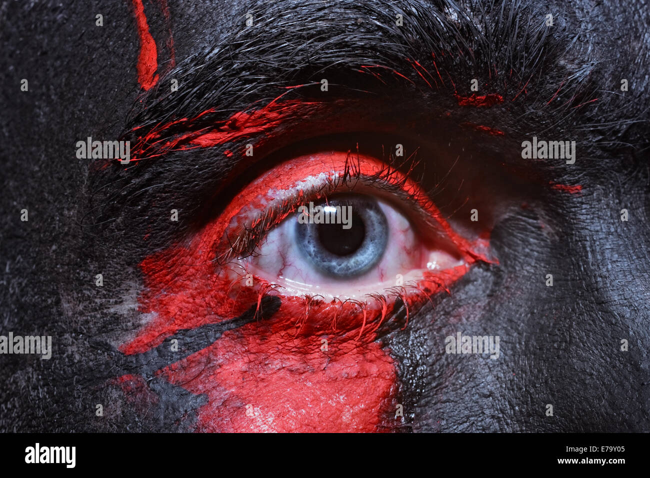 Male blue eyes bright with war paint closeup Stock Photo