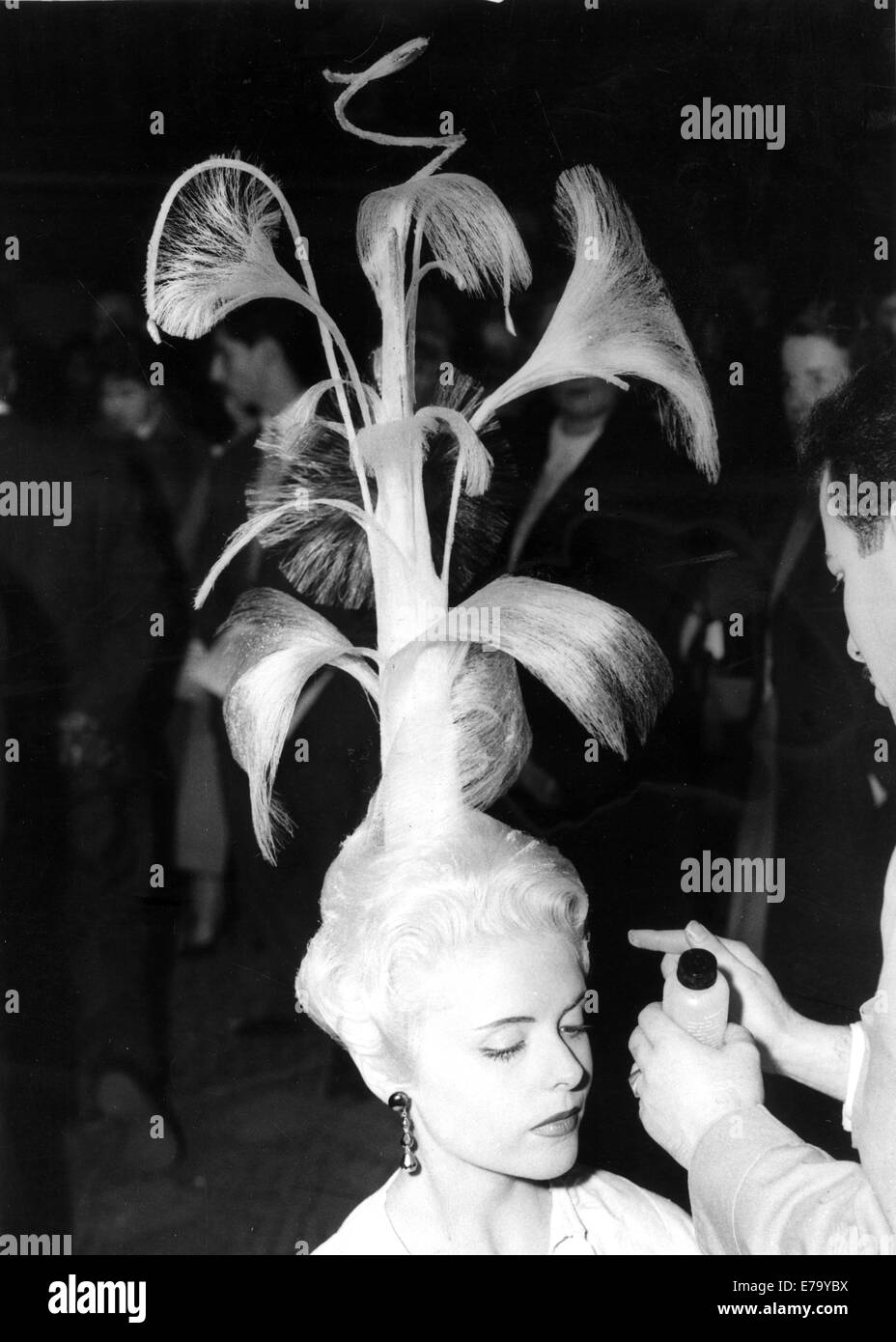 London, UK, UK. 11th Mar, 1958. Hairdresser, stylist Mr Baldjian, of Paris, preparing his hair creation called 'Feu de Artifices' (Fireworks) on model Nicole, at The Fellowship International Fantasy Competition at Seymour Hall in London. © KEYSTONE Pictures/ZUMAPRESS.com/Alamy Live News Stock Photo