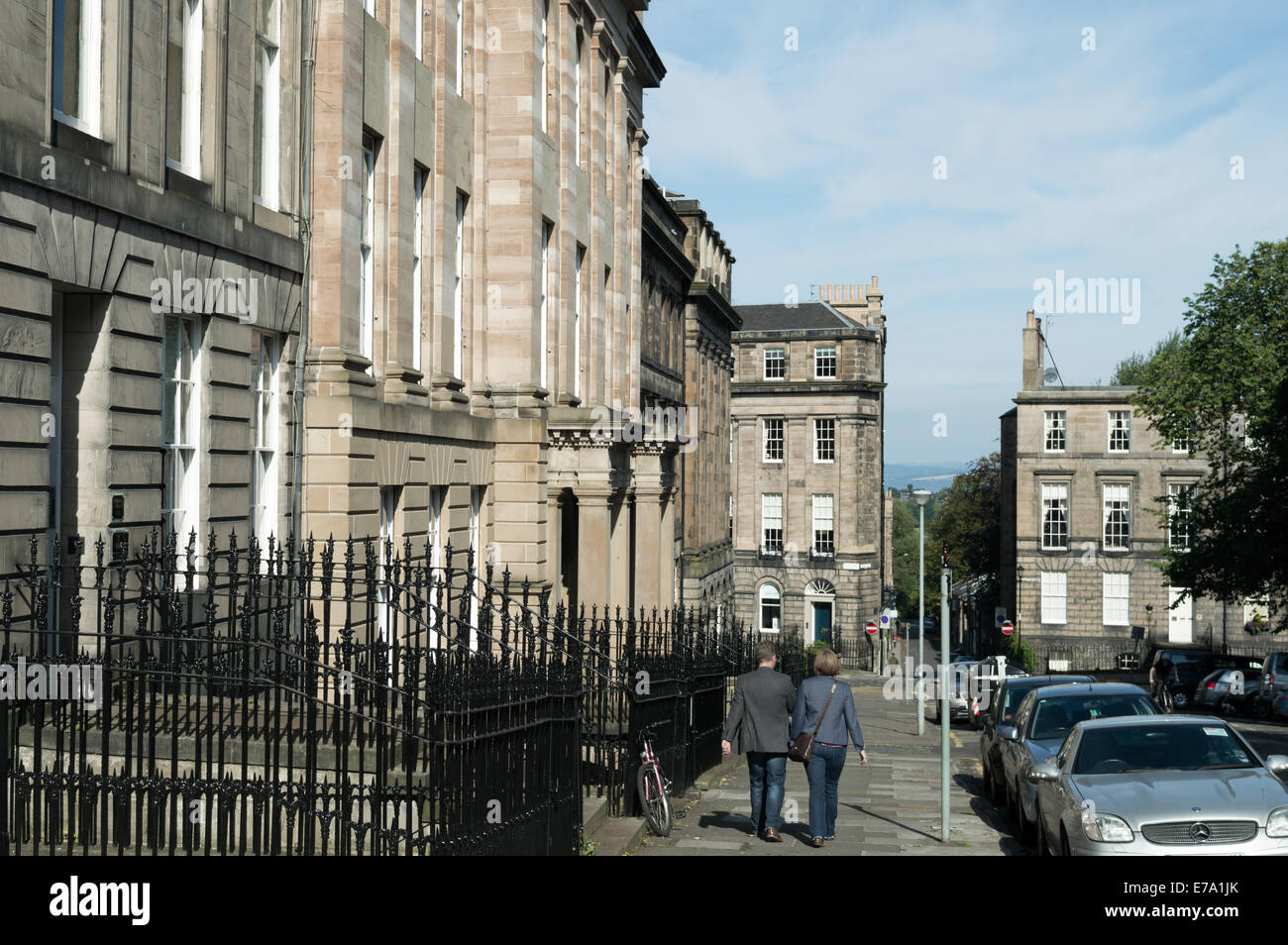 Man and woman walking along the street in Wemyss Place. Edinburgh New Town Stock Photo