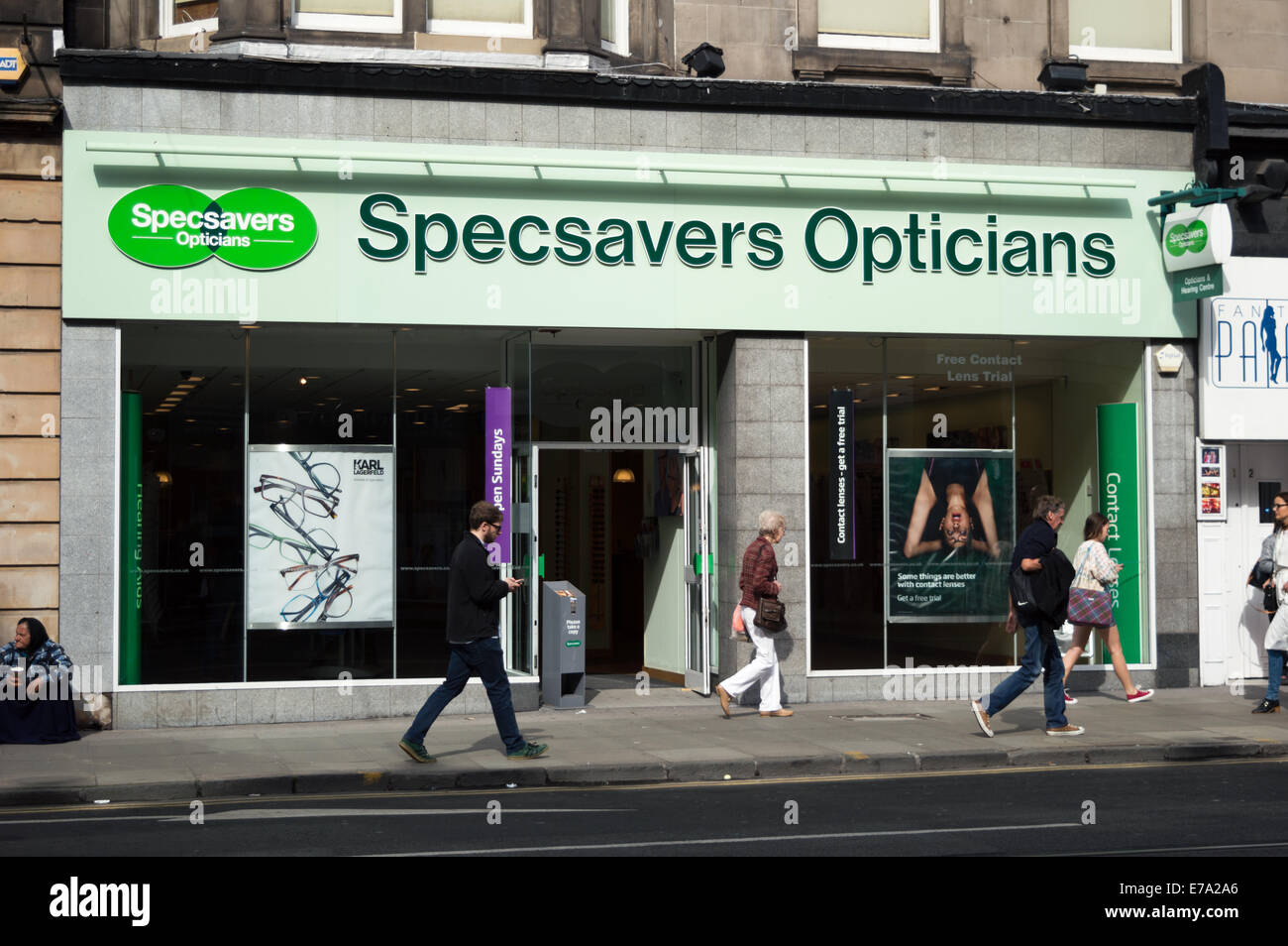 Shoppers walking past Specsavers Opticians in Edinburgh city centre. Stock Photo