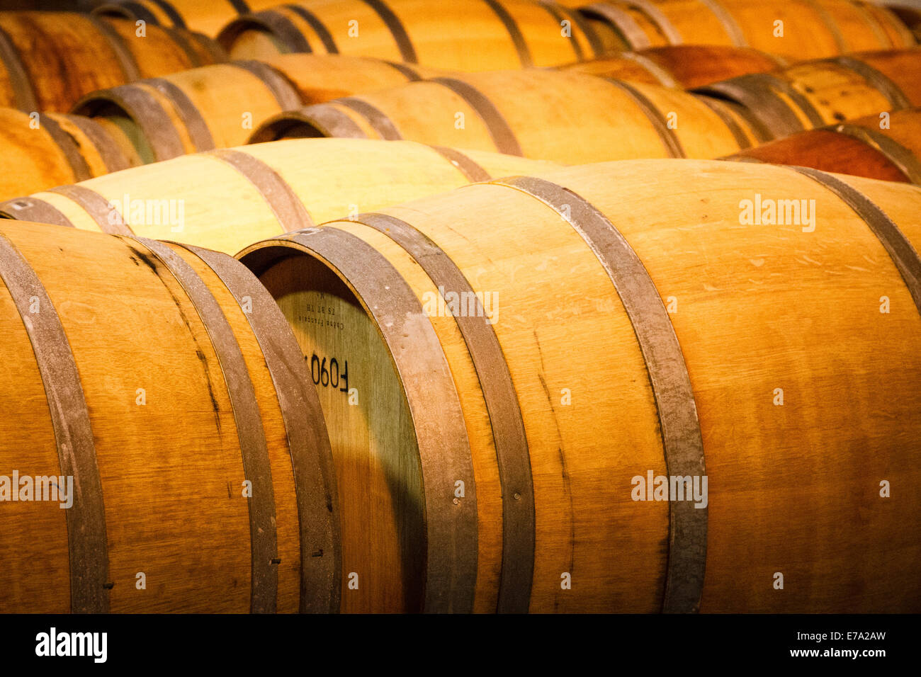 Wooden barrels of wine being stored at the vineyard cellar of Clos LaChance winery in San Martin, California Stock Photo