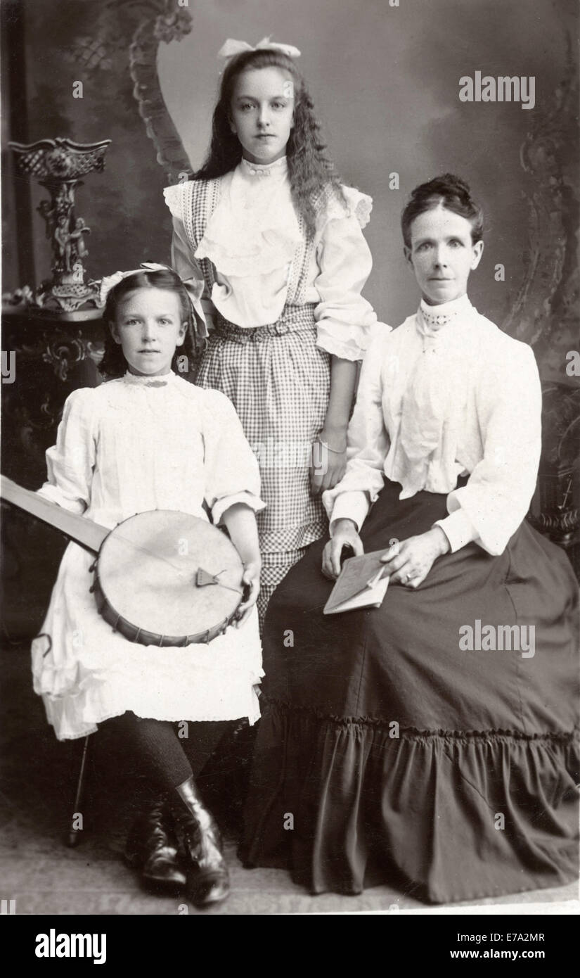 Mother with Two Daughters, one Holding String Instrument, Portrait, circa 1910 Stock Photo