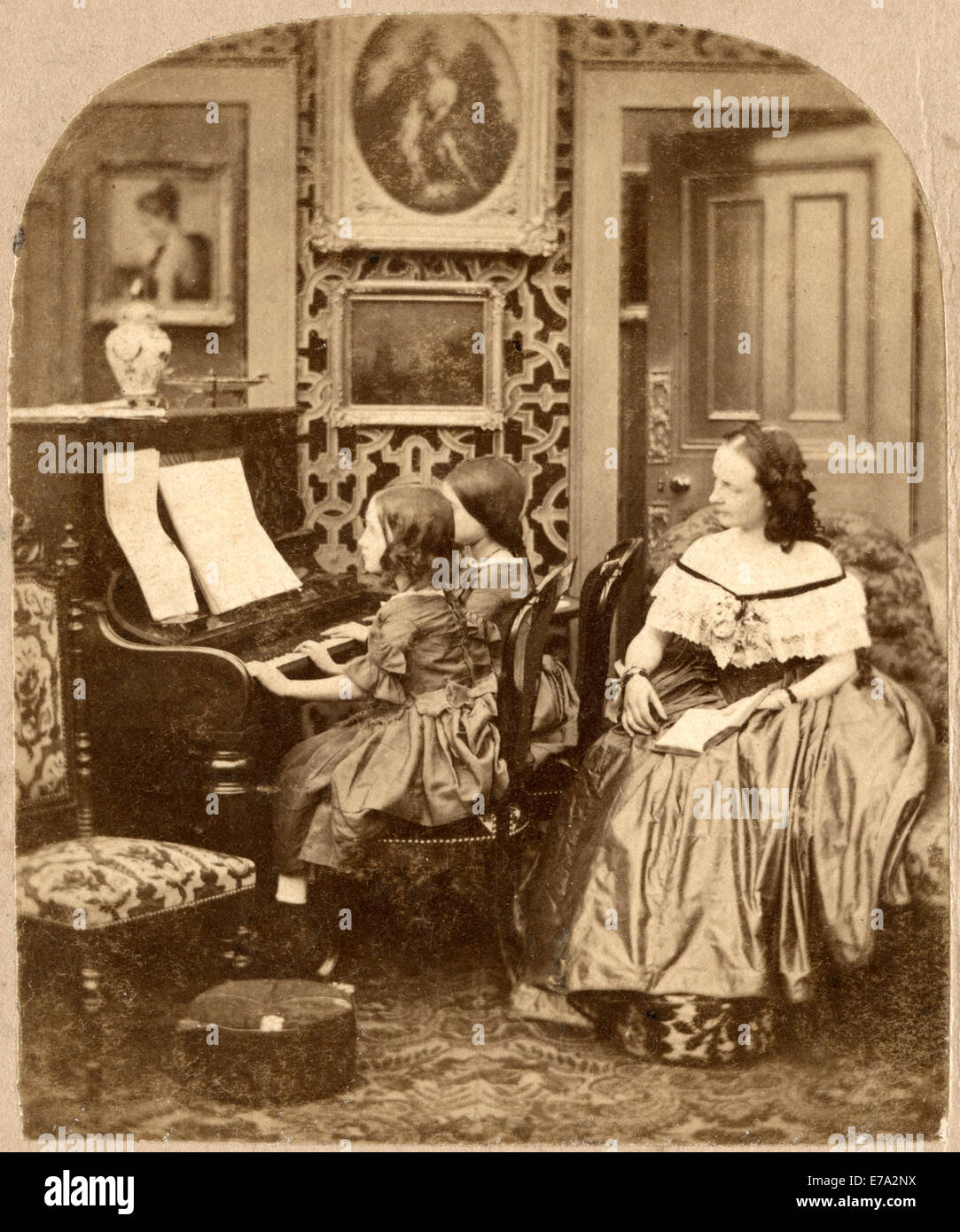 Seated Woman Behind Two Seated Girls Playing Piano, Evening Music, Single Image of Stereo Card, circa 1890 Stock Photo