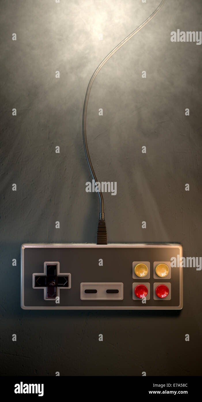 A regular vintage rectangular gaming controller with red and yellow buttons on an isolated dark spotlit studio background Stock Photo