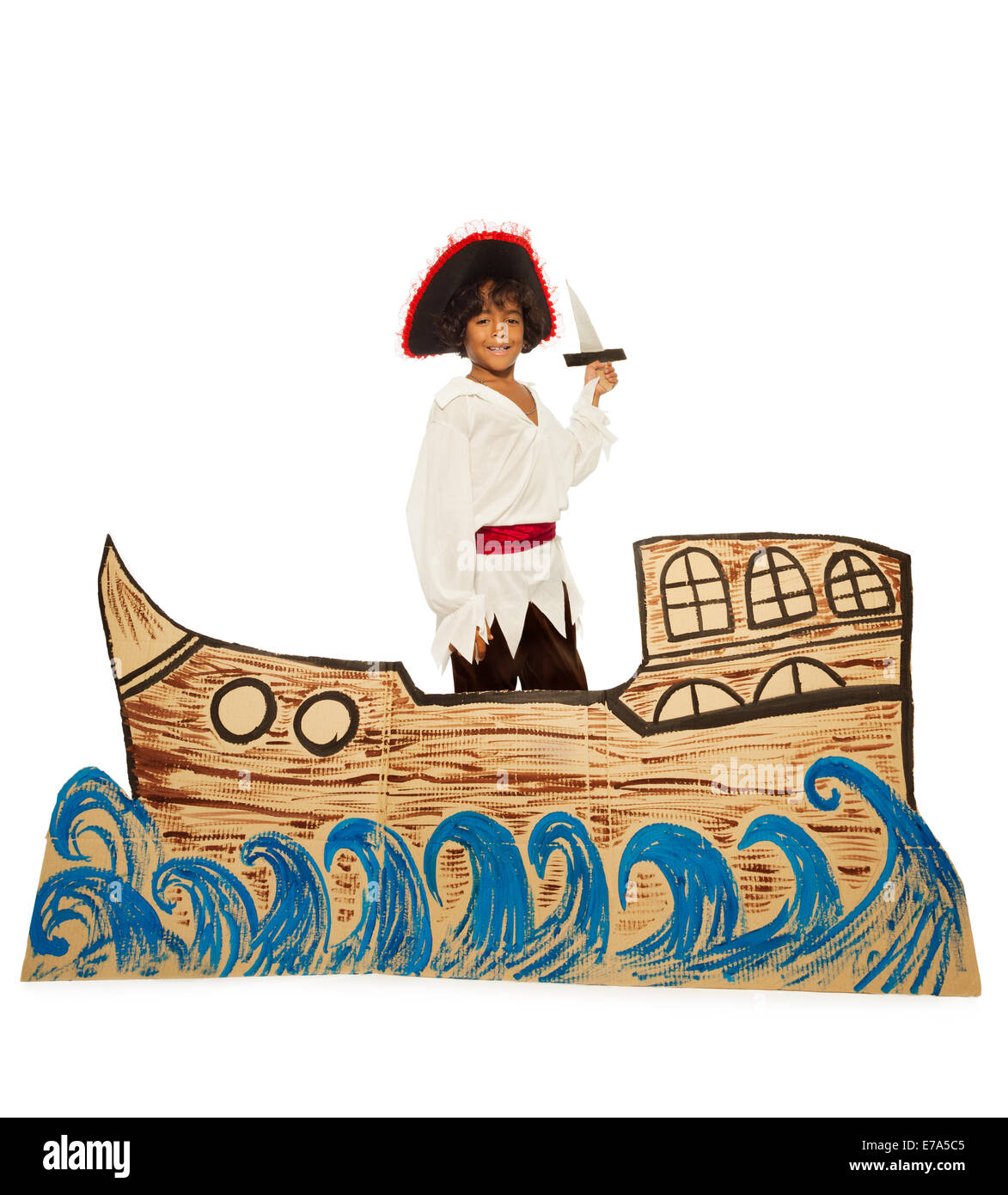 Black boy in costume of pirate on cardboard ship Stock Photo