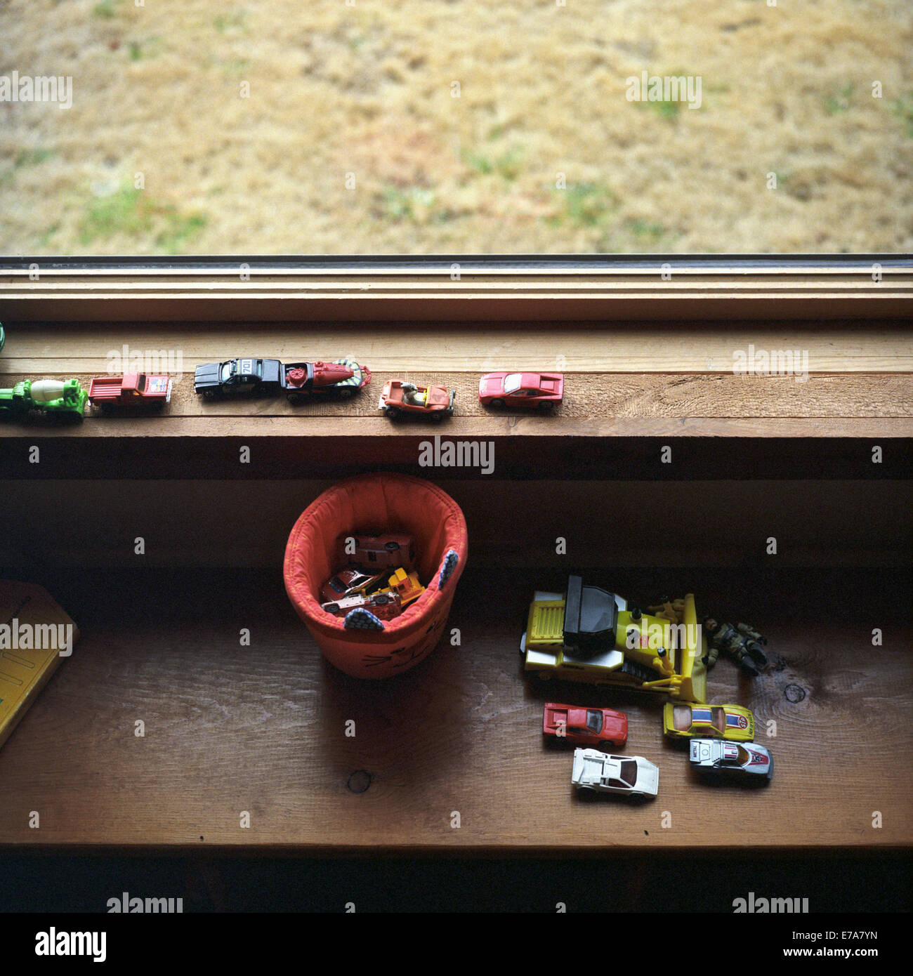 A collection of toy cars on a window sill Stock Photo