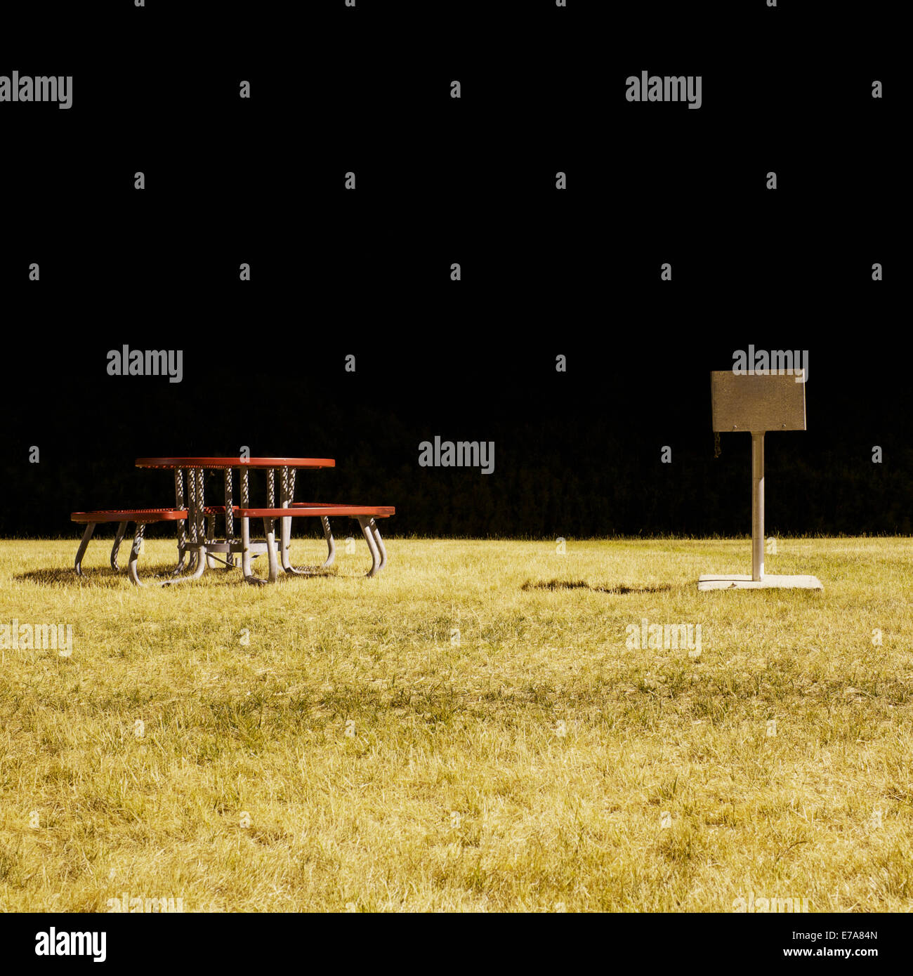 A picnic table and barbecue in a park at night, long exposure Stock Photo