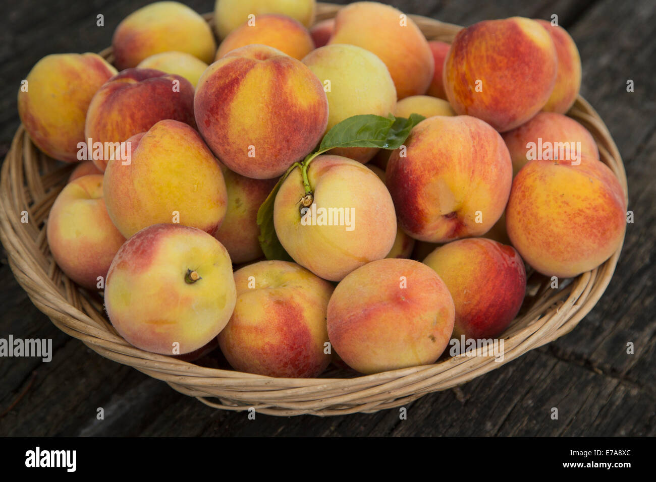 Close-up of peaches in basket Stock Photo