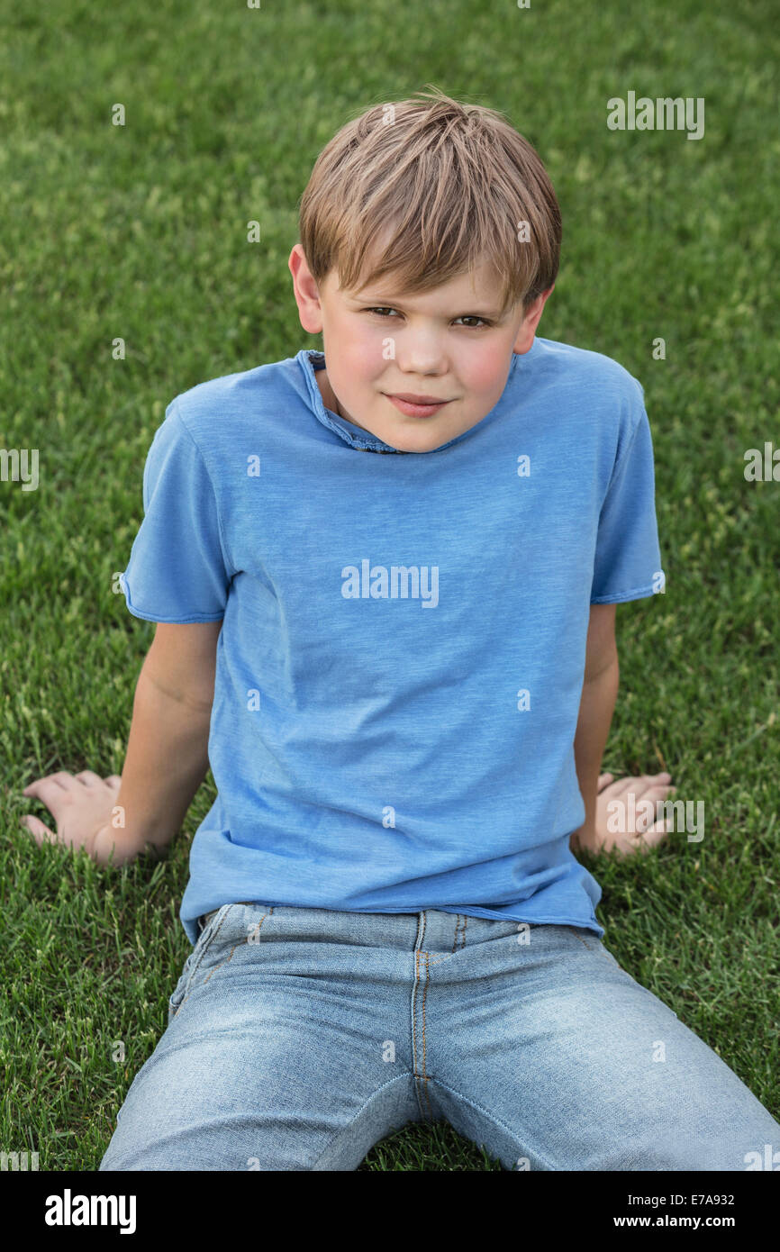 Portrait of boy relaxing in park Stock Photo