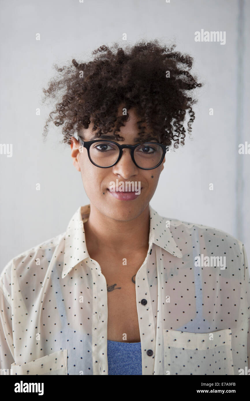 Portrait of smiling woman with curly hair Stock Photo - Alamy