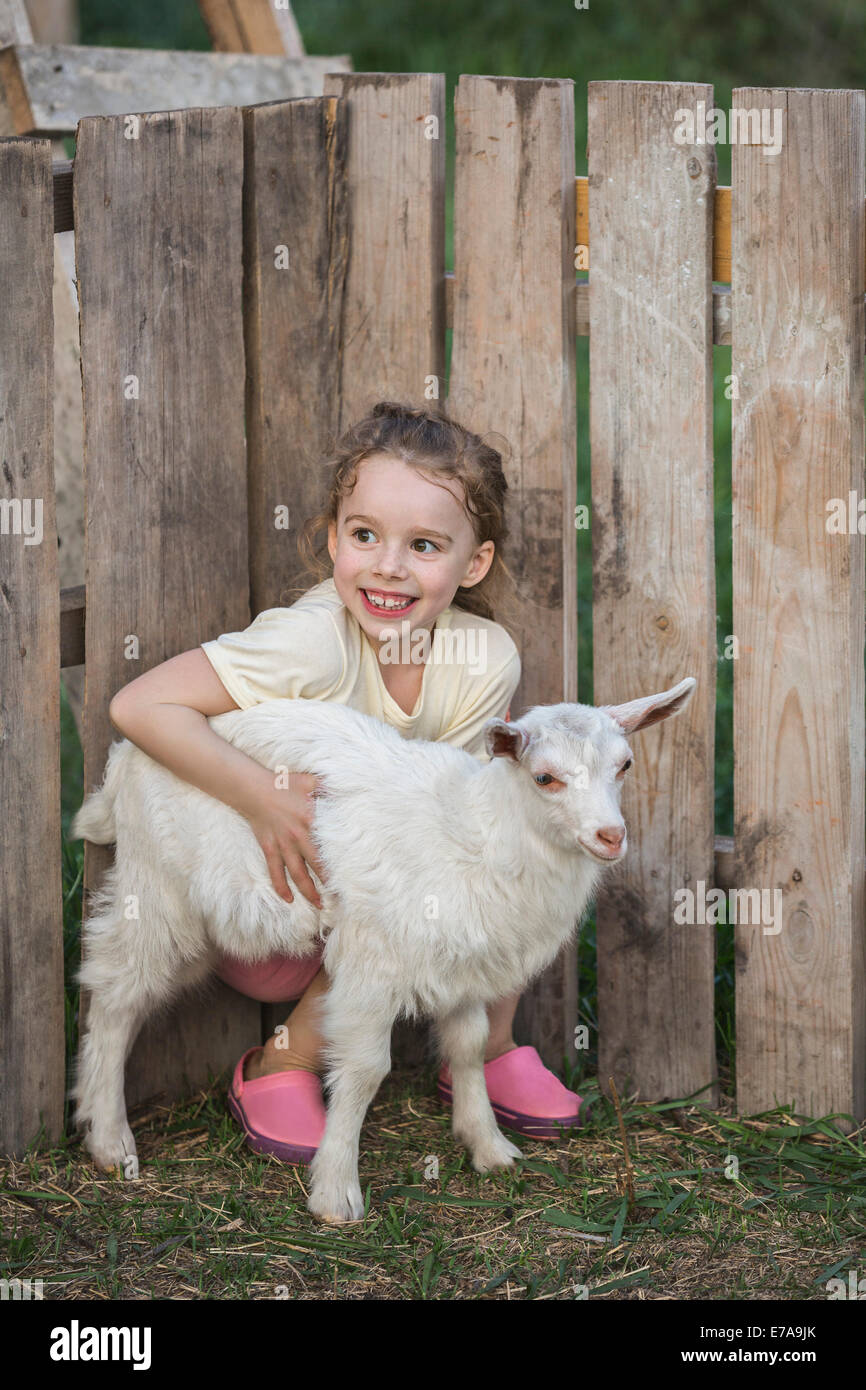 Young girl holding baby goat hires stock photography and images Alamy