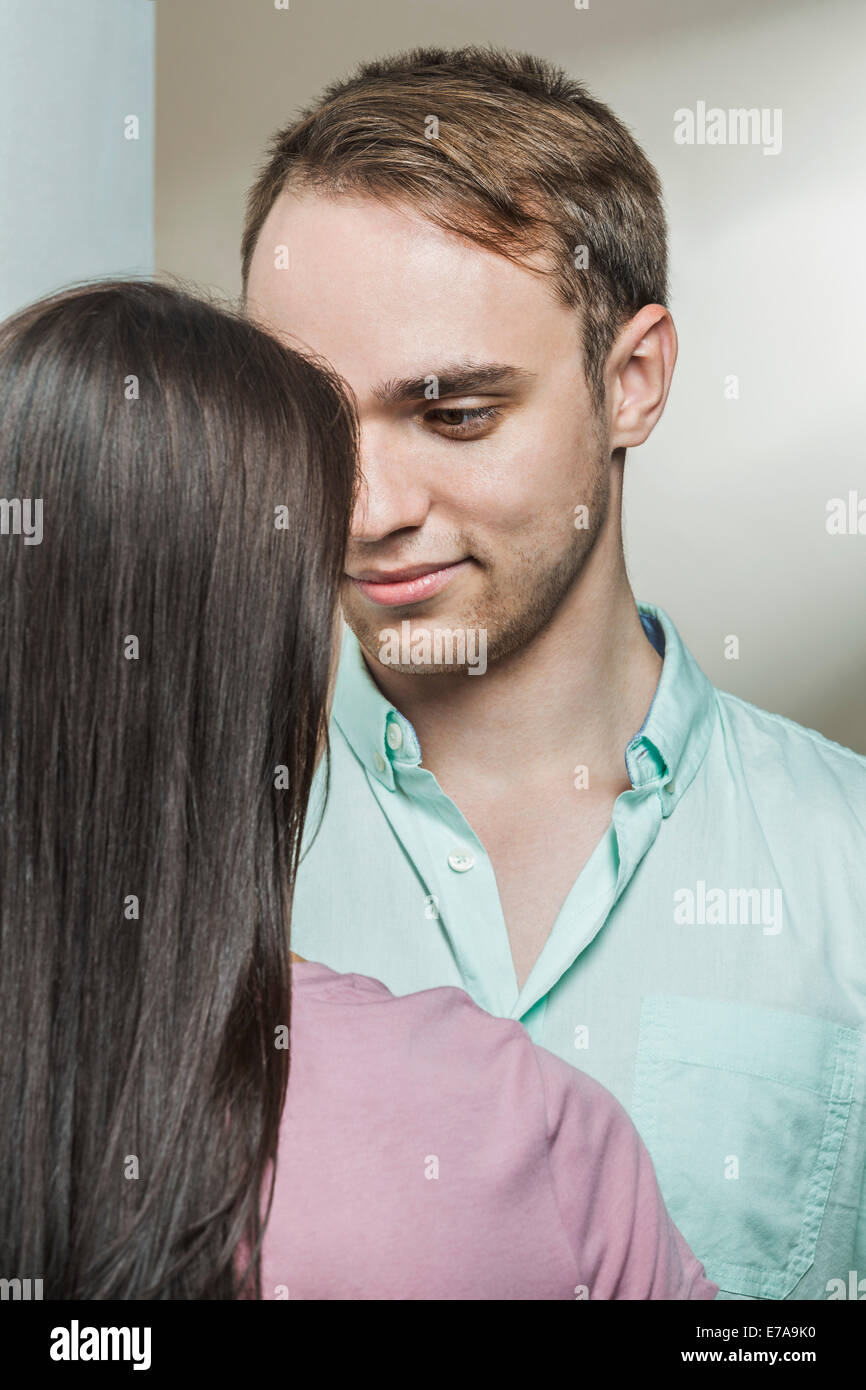 Loving man looking woman in house Stock Photo