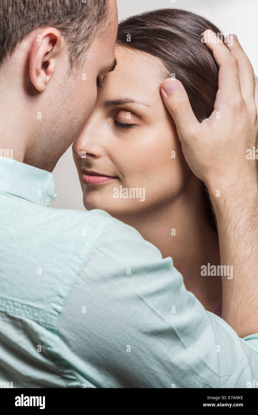 Close-up of loving couple with head to head at home Stock Photo