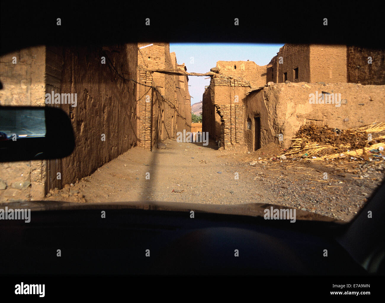 View of old ruin buildings through windshield, Agdz, Morocco Stock Photo