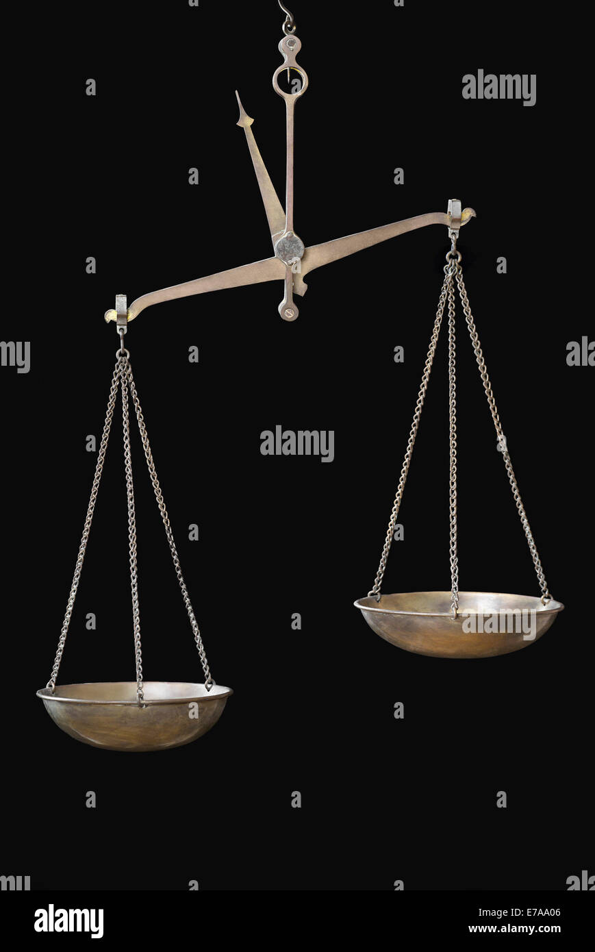 Equal-arm balance hanging against black background Stock Photo