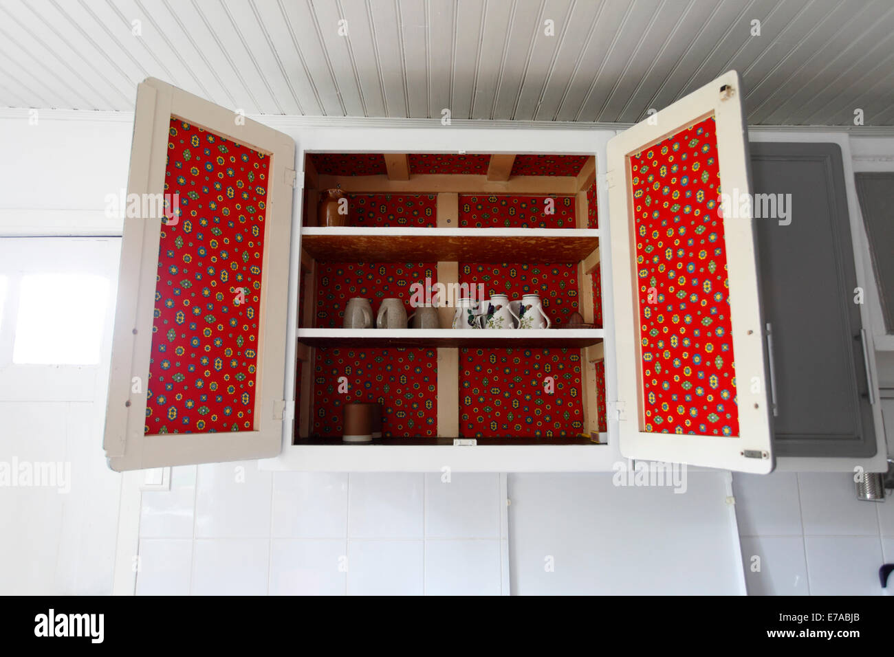 vintage kitchen cupboard with red fablon inside. Stock Photo