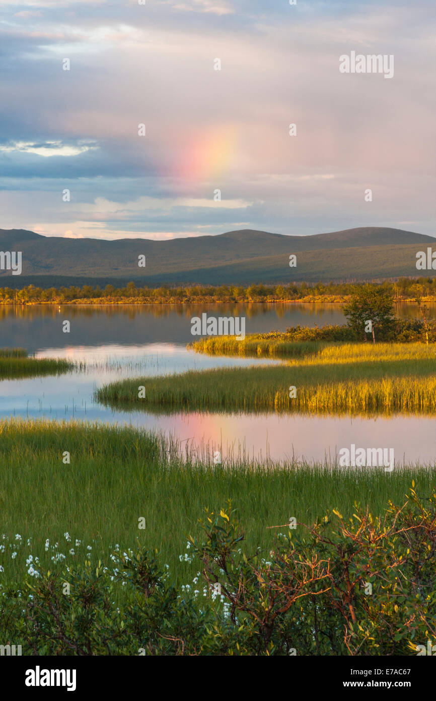 Paitasjärvi in Nikkaluokta in sunset with rainbow appearing, Kiruna, Swedish lapland Stock Photo