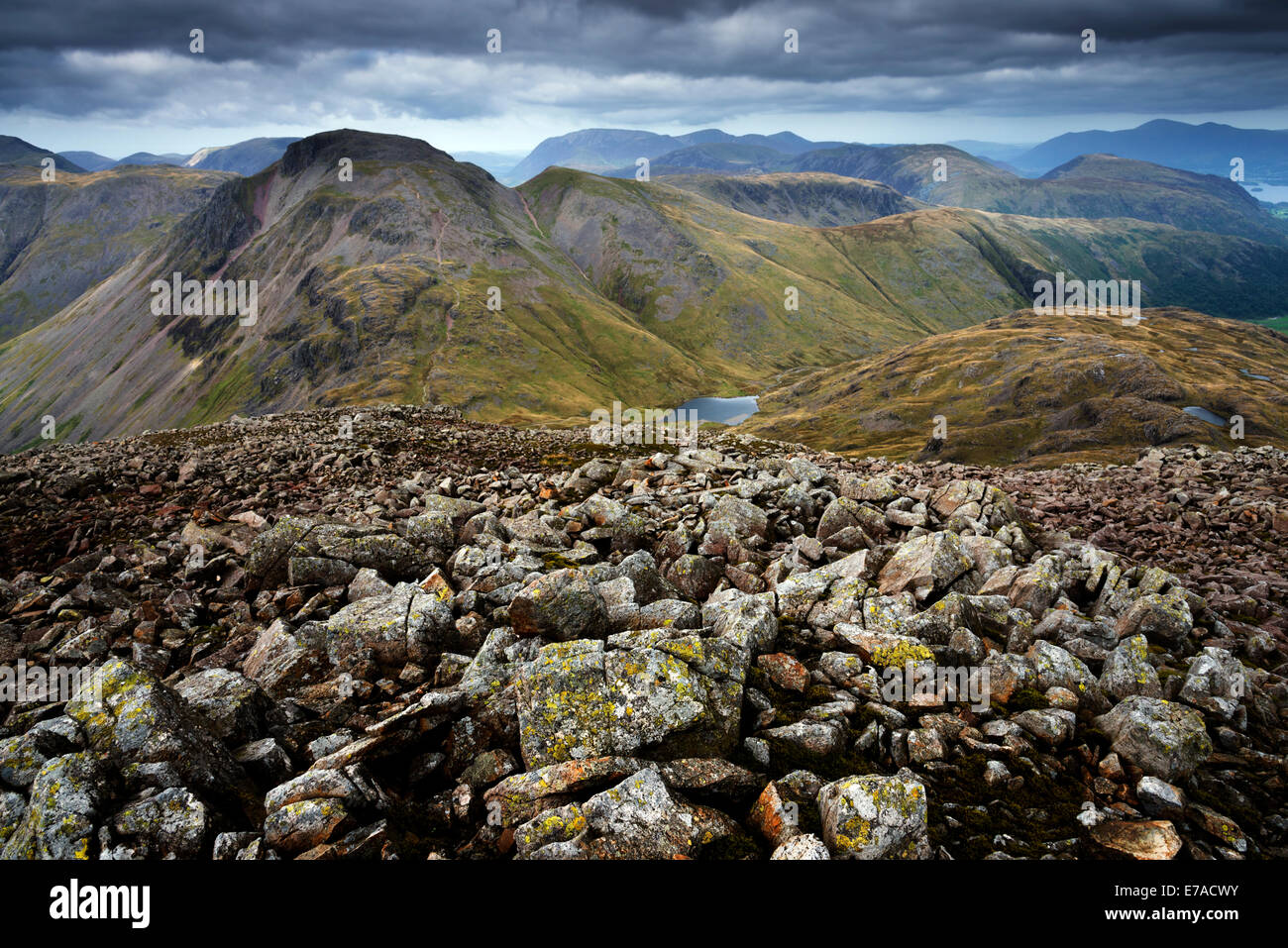 Loose sandstones at the summit of Great End looking towards Great Gable and Green Gable Stock Photo