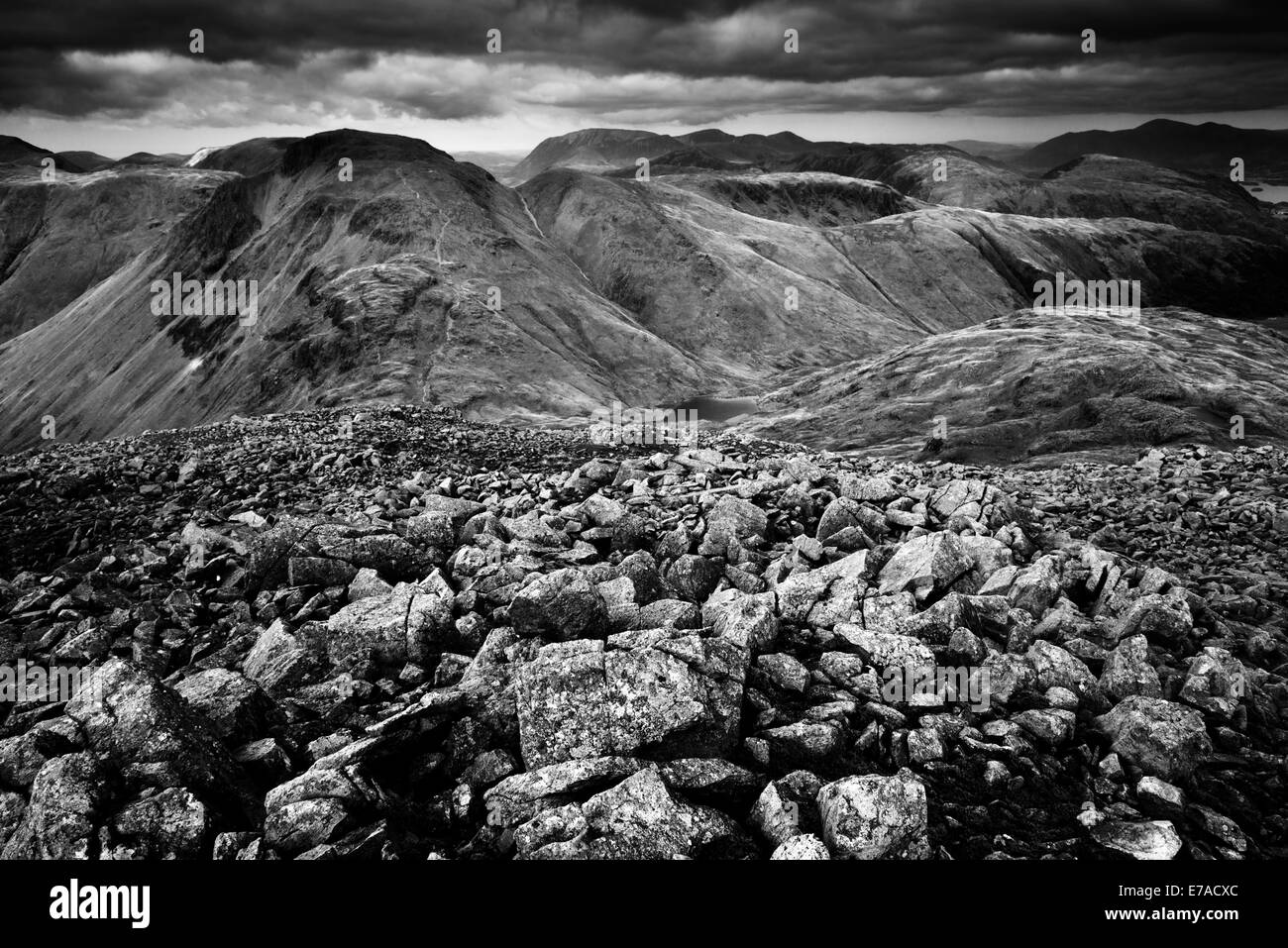 Loose sandstones at the summit of Great End looking towards Great Gable and Green Gable Stock Photo
