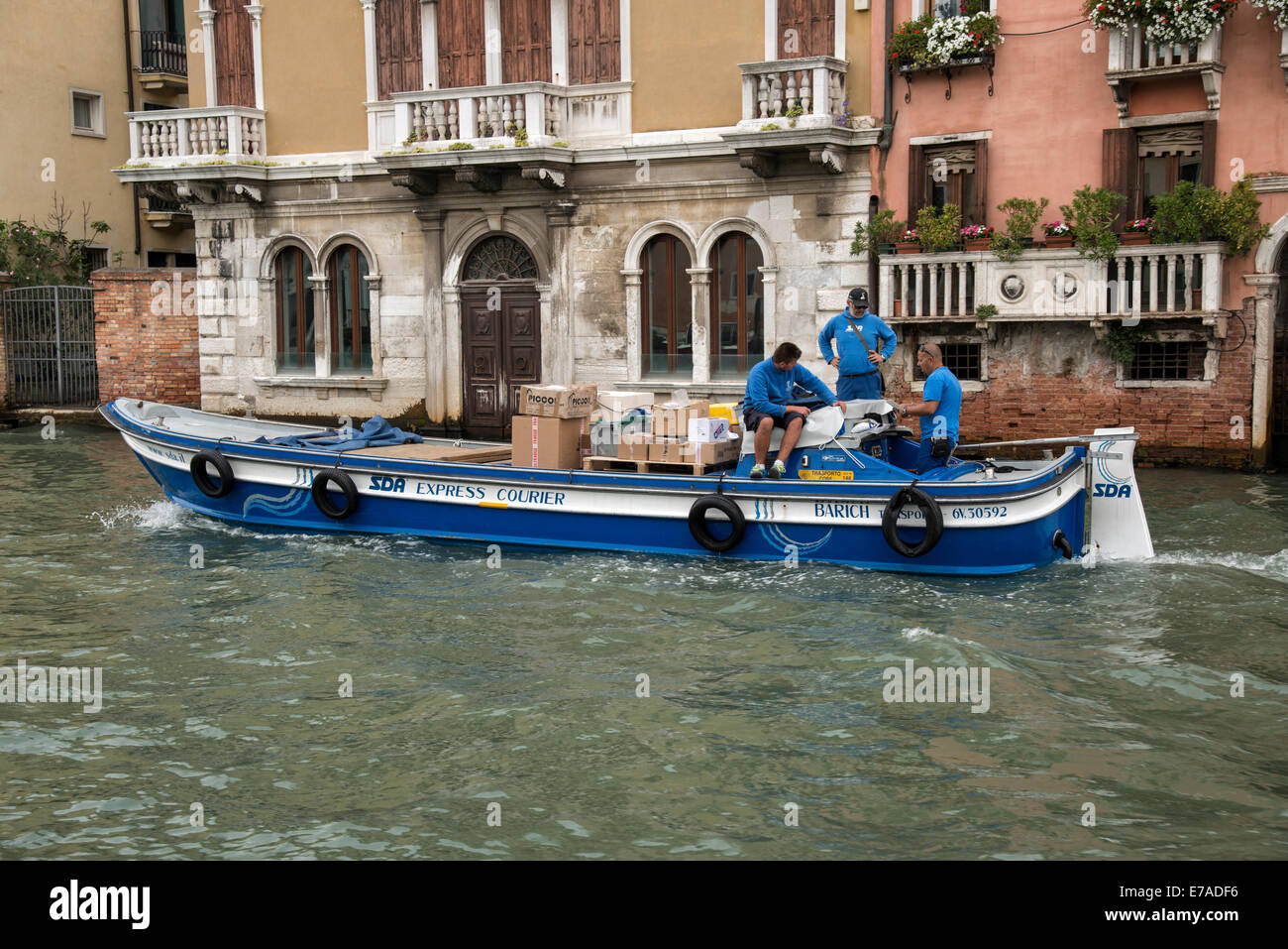Express Courier boat delivering parcels along the Grand Canal in Venice Stock Photo