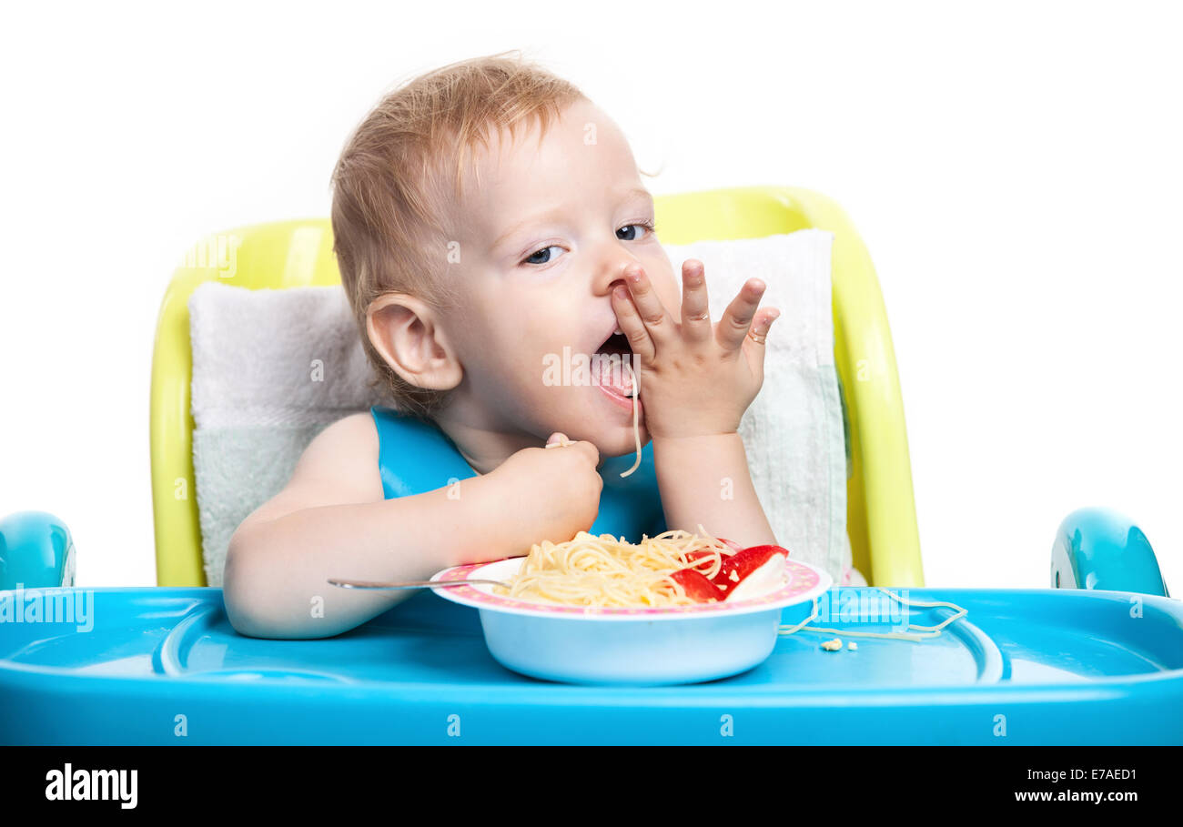 Little blond boy eating spaghetti Stock Photo