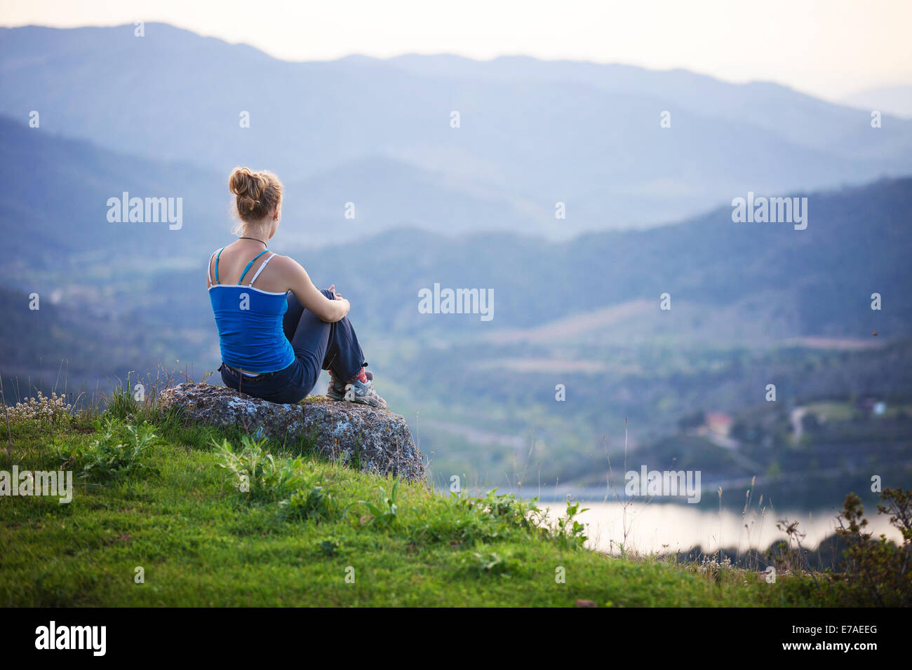 Girl sitting on high hill hi-res stock photography and images - Alamy