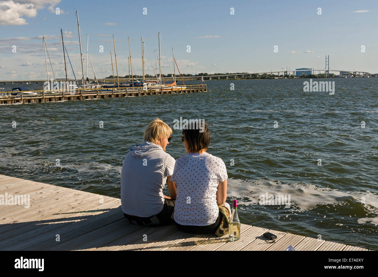 Young couple enjoying the view over the Strelasund to Stralsund from Altefähr on the island of Rügen, Mecklenburg, Germany. Stock Photo