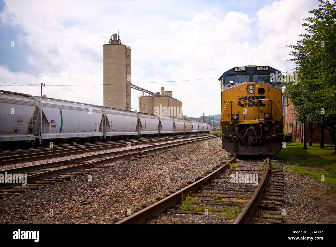 On coming CSX Diesel Locomotive and Industrial Rail Cars on train Tracks in Kingsport, Tennessee Stock Photo