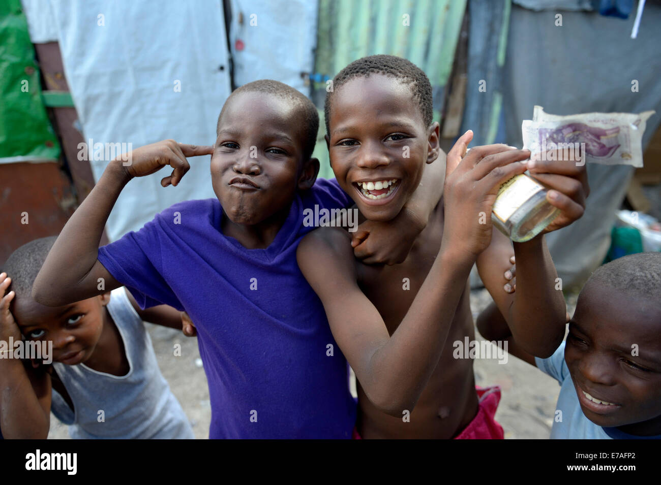 Two boys posing with money, alcohol and gesture of a gun, gestures for the criminal idols of the children, Camp Icare for Stock Photo