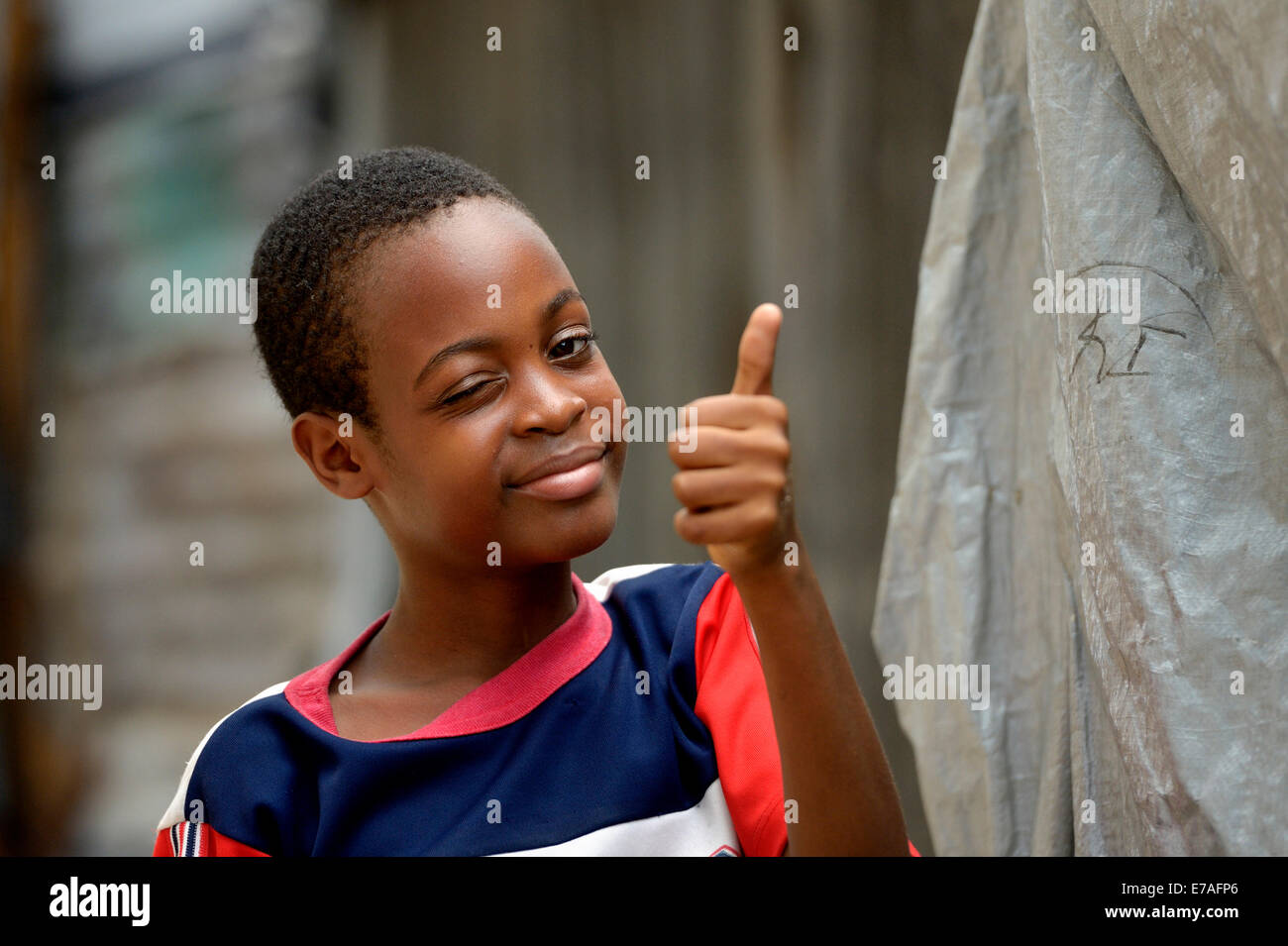 Young winking and giving his thumbs up, Camp Icare for earthquake refugees, Fort National, Port-au-Prince, Haiti Stock Photo