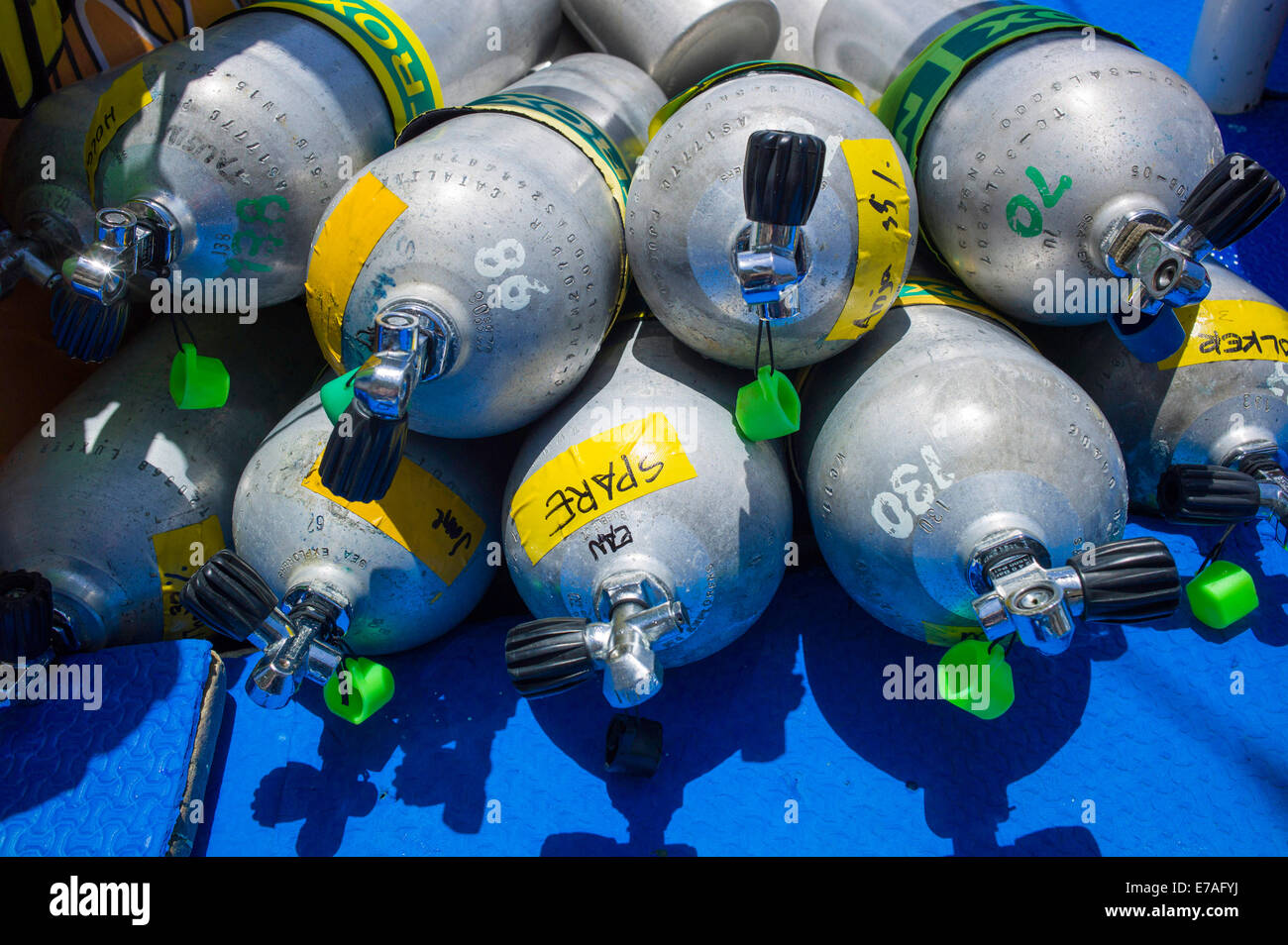 Compressed air cylinders or scuba tanks lying in a diving boat, Philippines Stock Photo