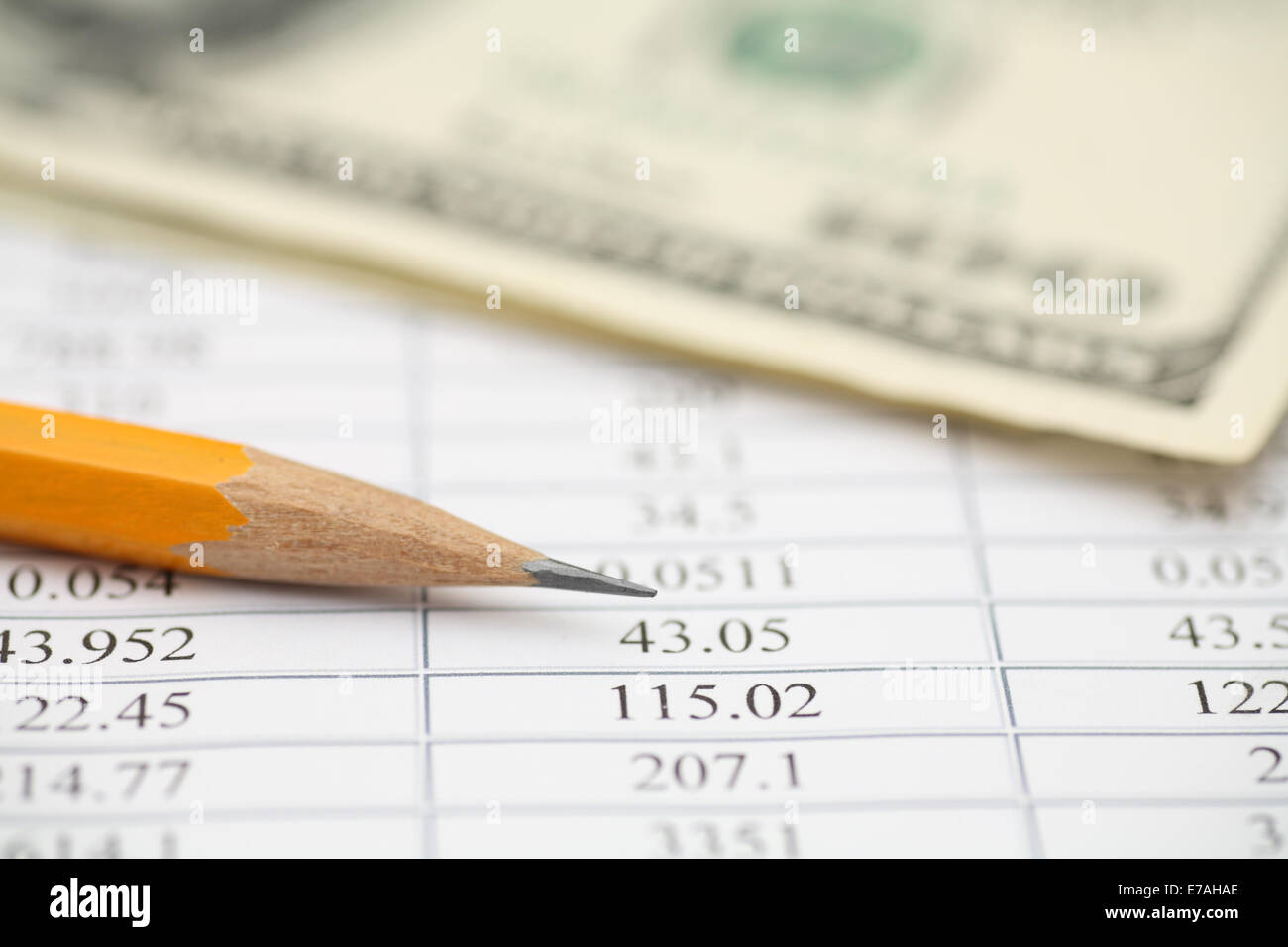 Financial statements, pencil and one hundred dollars. Shallow depth of field. Closeup. Stock Photo