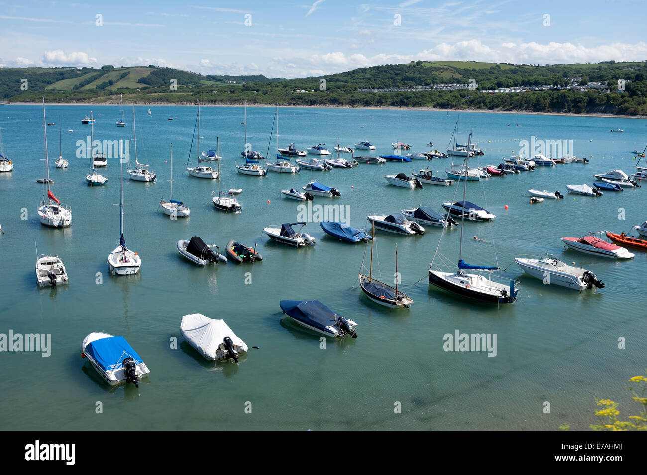Boats Moored in Deep Blue Water Sunny New Quay Wales Stock Photo