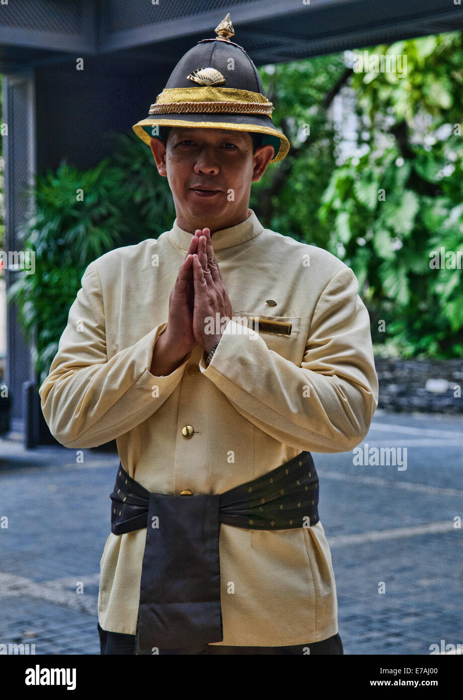 Hotel bell boy wai at Mandarin Oriental, Bangkok, Thailand Stock Photo