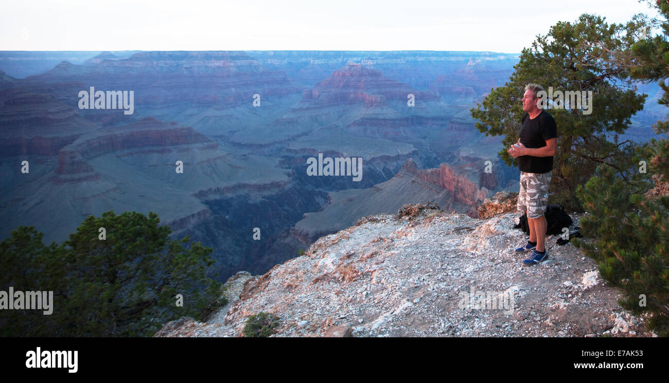 Man standing on the edge of the Grand Canyon, USA Stock Photo