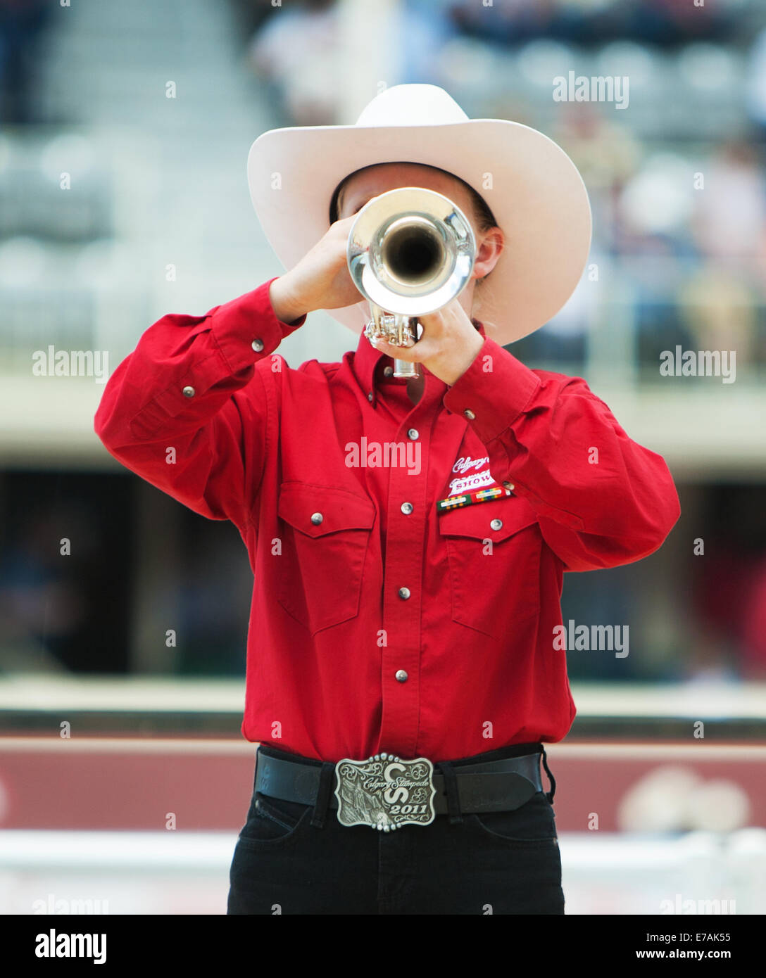 woman playing the trumpet wearing a red shirt at the Calgary Stampede, Canada. Stock Photo