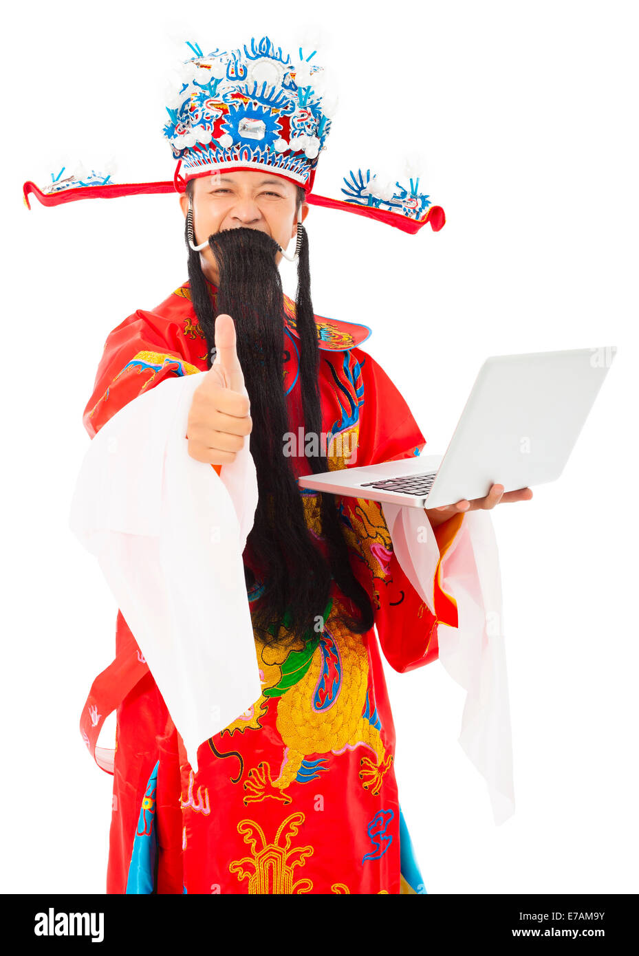 God of wealth holding a laptop and thumb up over white background Stock Photo