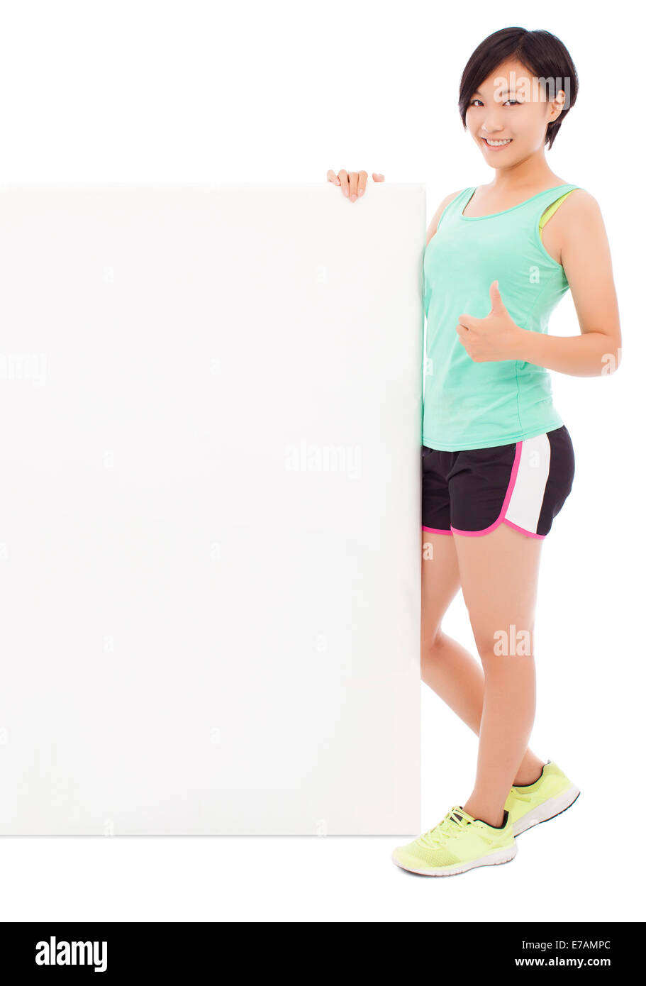 young female athletes holding a empty board and thumb up. isolated on white background Stock Photo