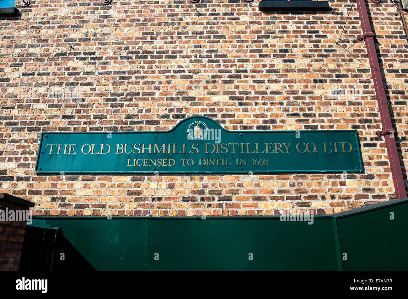 Old Bushmills Distillery sign on exterior wall of Old Bushmills Distillery, Bushmills, County Antrim, Northern Ireland. Stock Photo