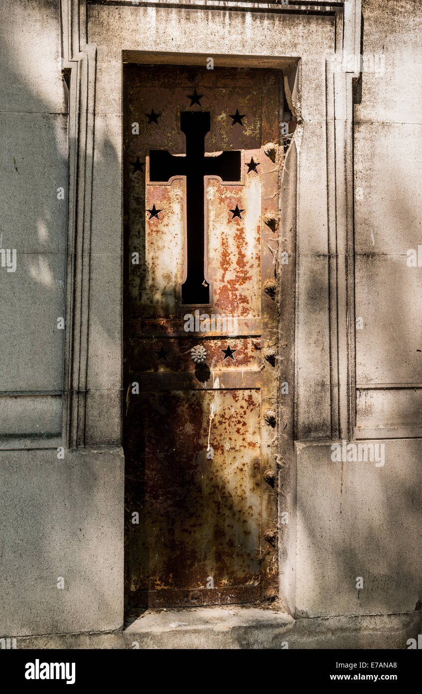 A rusty iron mausoleum door in a cemetery in Paris France. Stock Photo