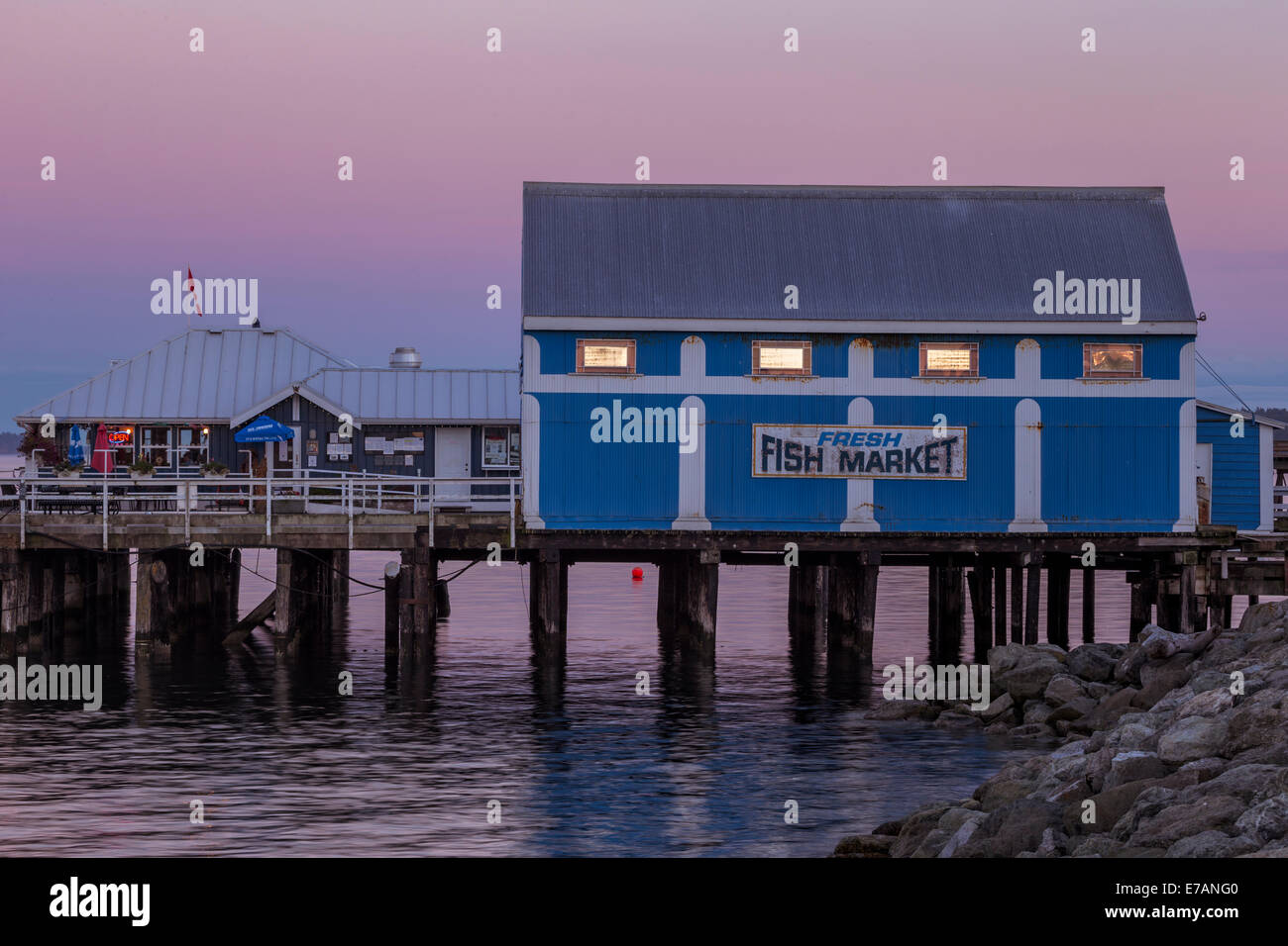 Blue fish market building on Sidney Pier at dusk-Sidney, British Columbia, Canada. Stock Photo