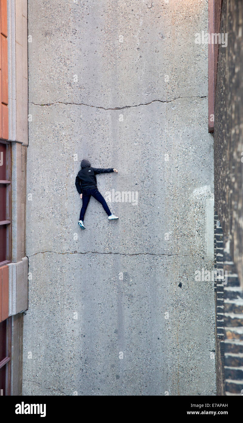 An unconscious person lying face down in an urban alley Stock Photo