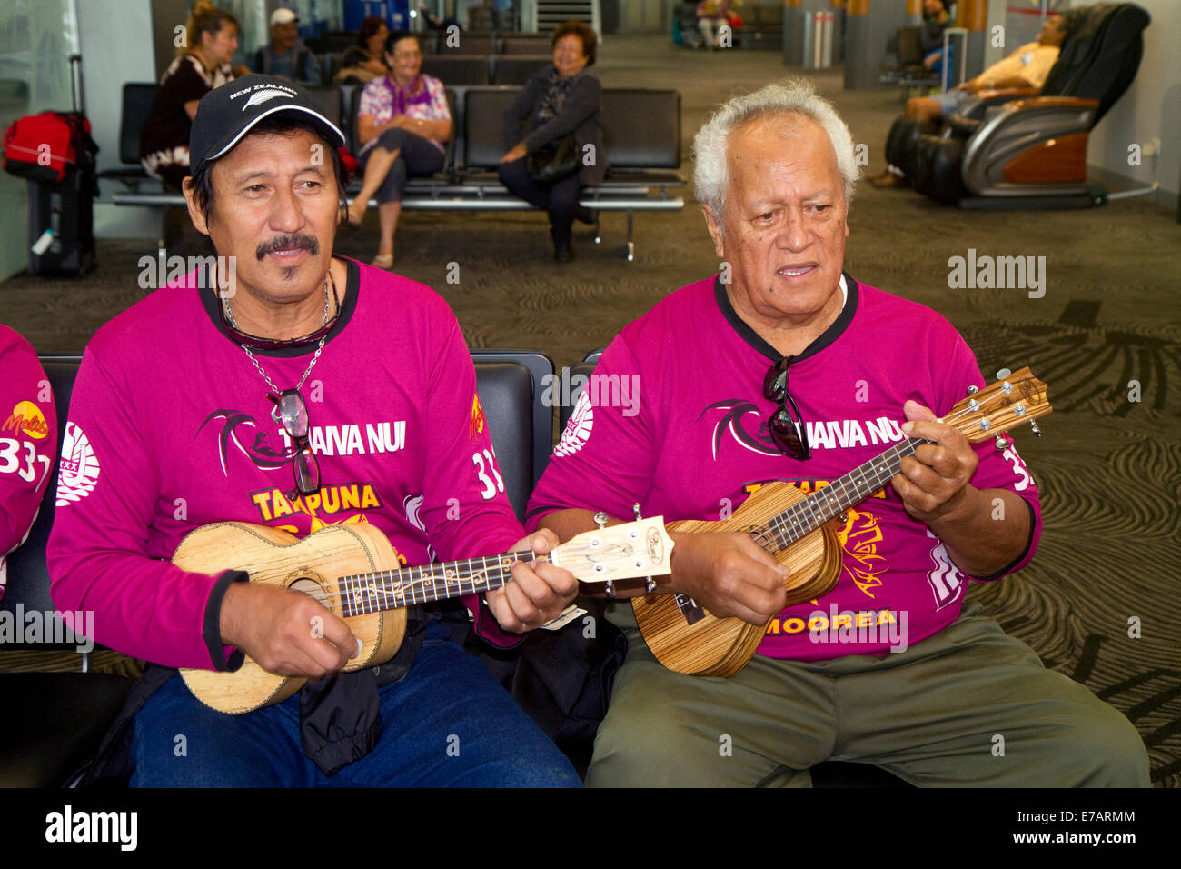Tahitian men play ukulele at the Auckland Airport, Auckland, North Island, New Zealand. Stock Photo