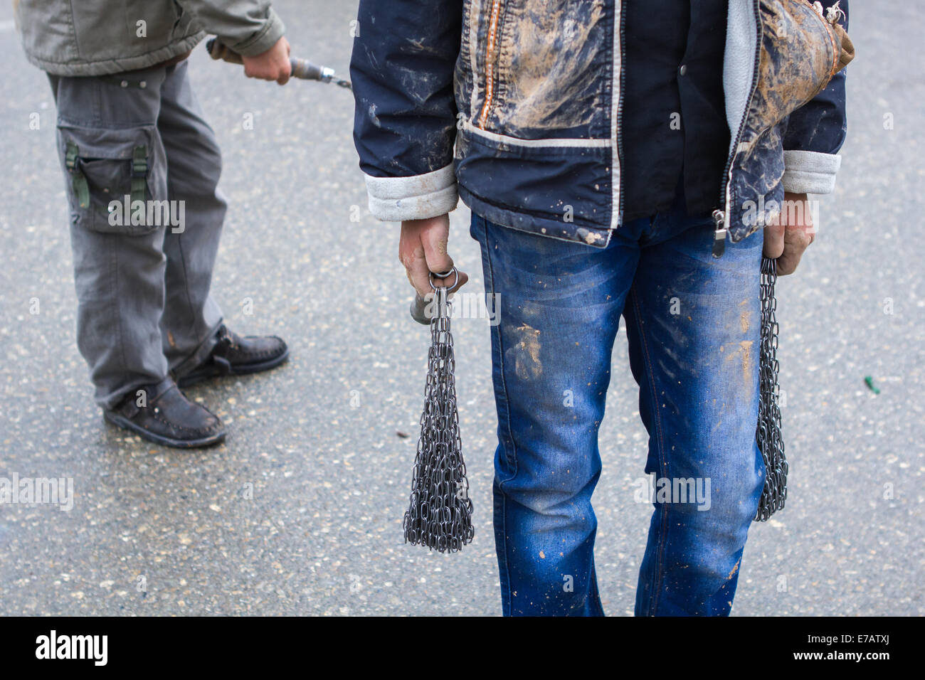 Young Shiite Muslim boys, carrying heavy iron chains used for self-flagellation, on Ashura Day, in Bijar, Iran. Stock Photo