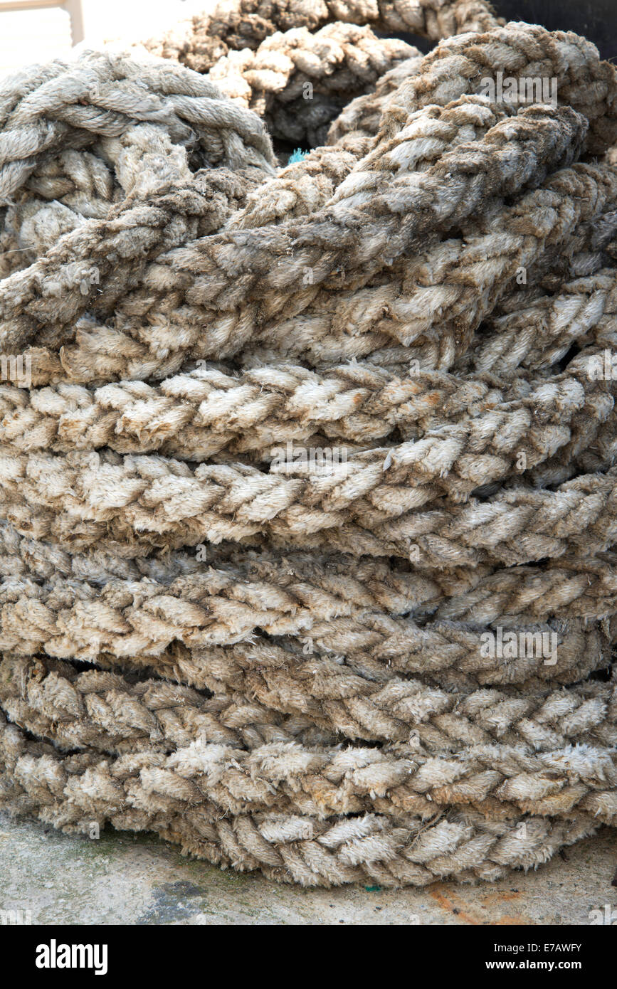 Detail of coiled rope on quayside Stock Photo