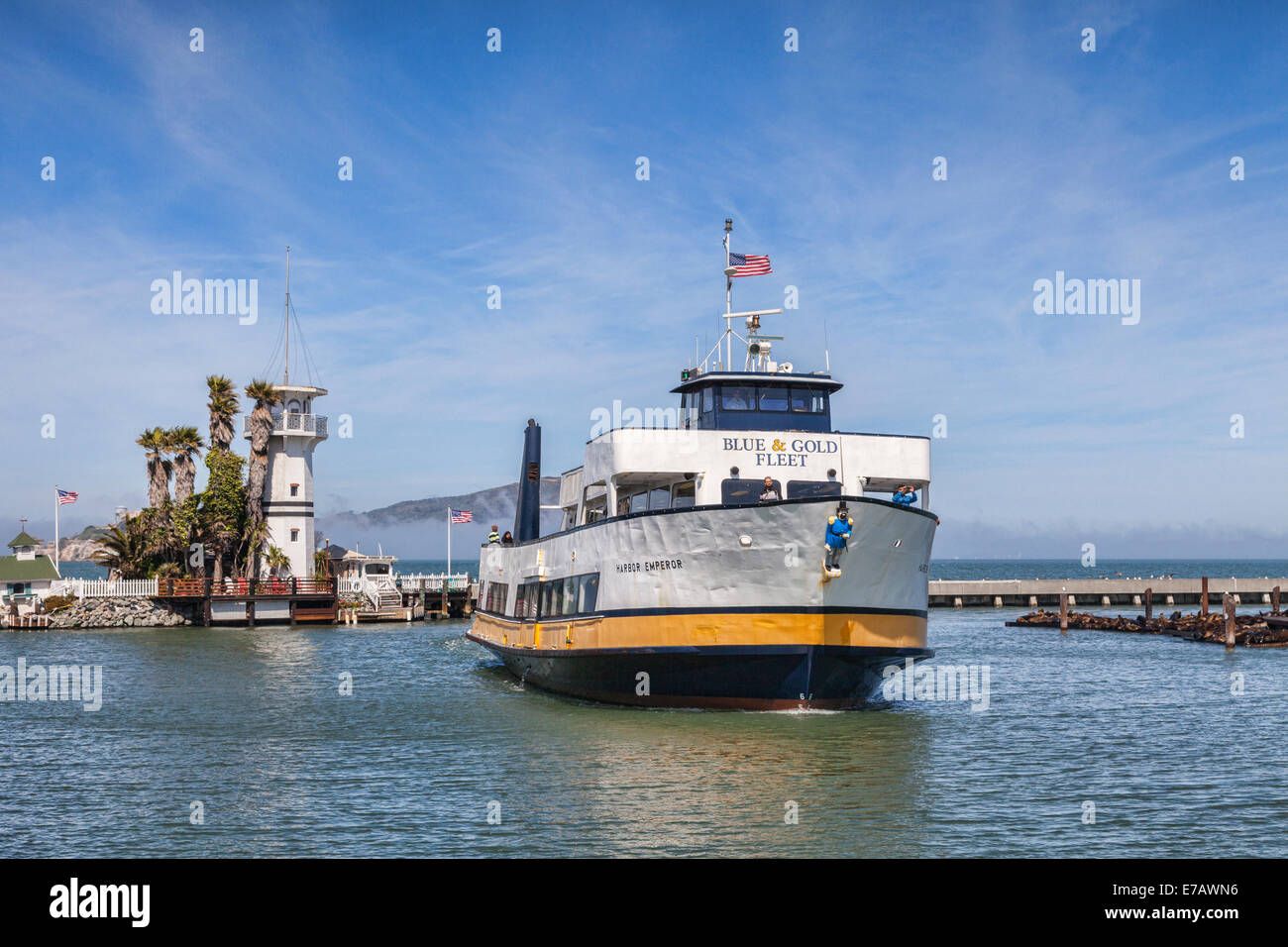 Cruise boat Harbor Emporor, of the Blue and Gold Fleet, returns to its berth in San Francisco Bay near Pier 39, passing between Stock Photo