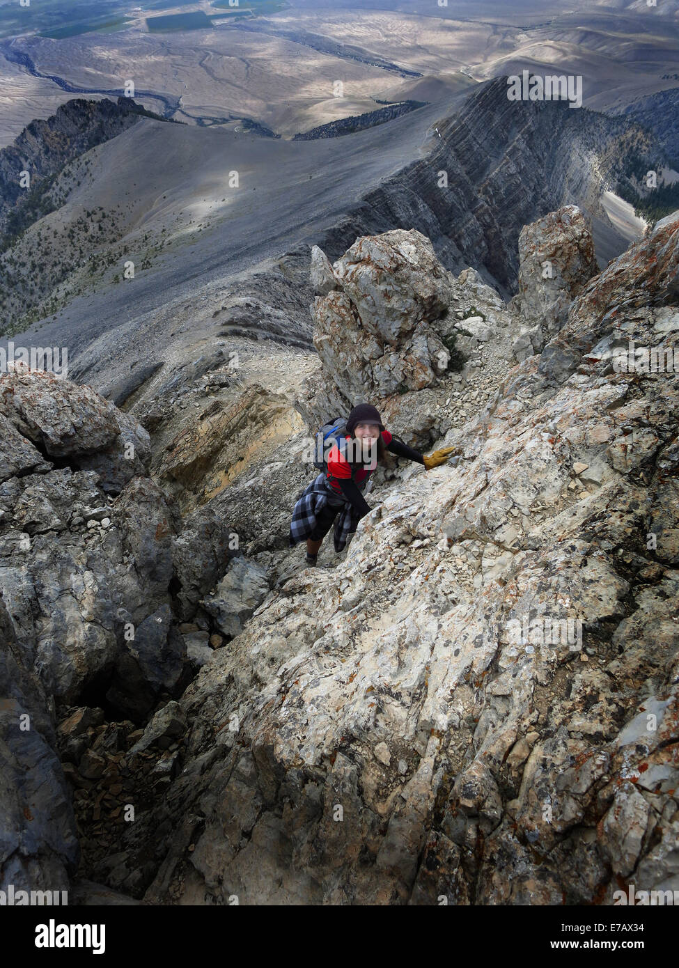 Girl hiker summit mountain top in triumph Stock Photo